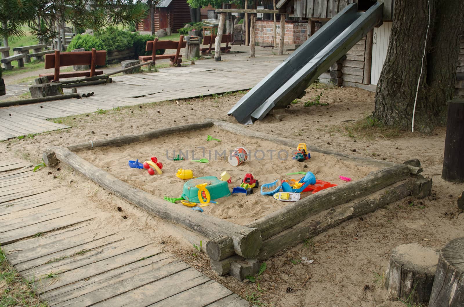 sandbox playground full of toys scattered on children recreationpark in summer time