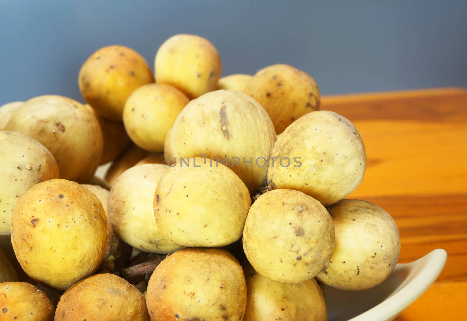 A bunch of Wollongong With golden color placed in a dish.                               