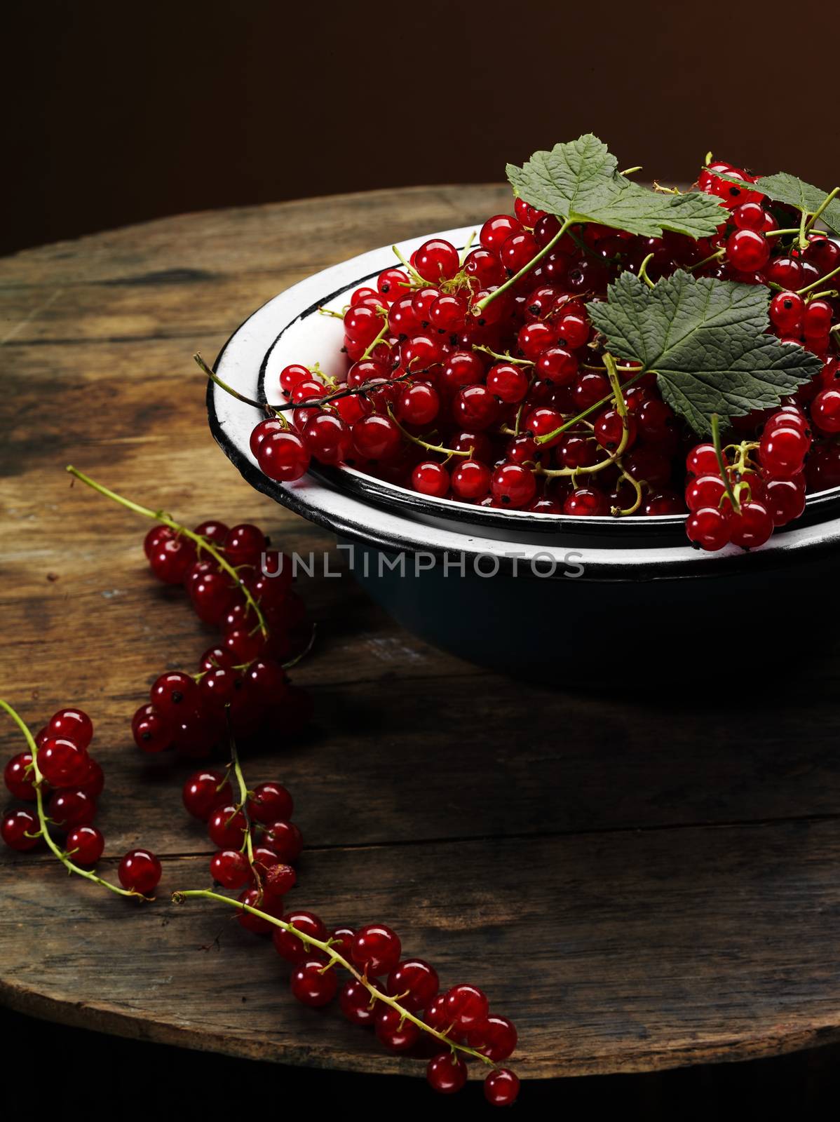 fresh ripe red currant bowl on the wooden table
