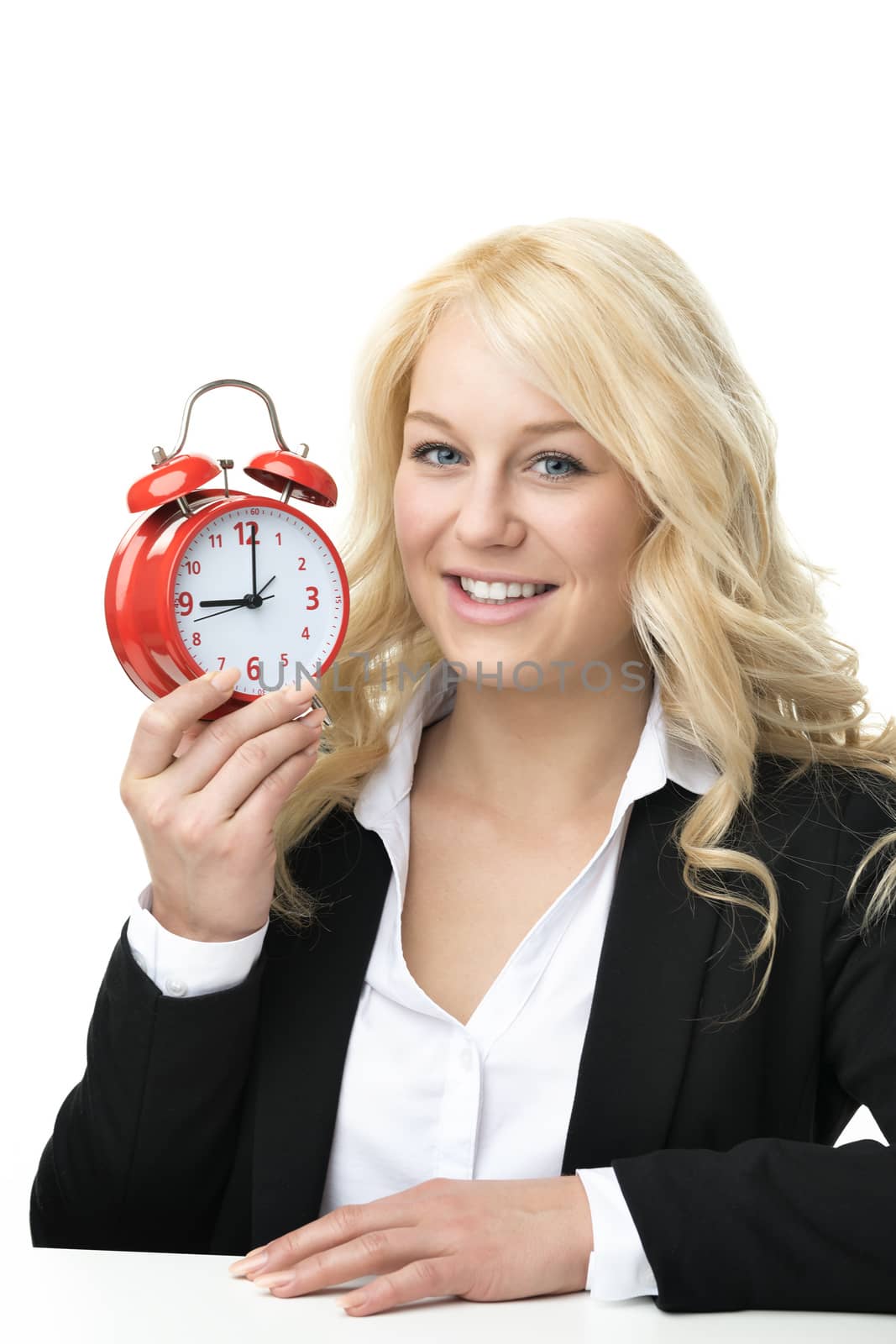 Laughing blond woman with red alarm clock