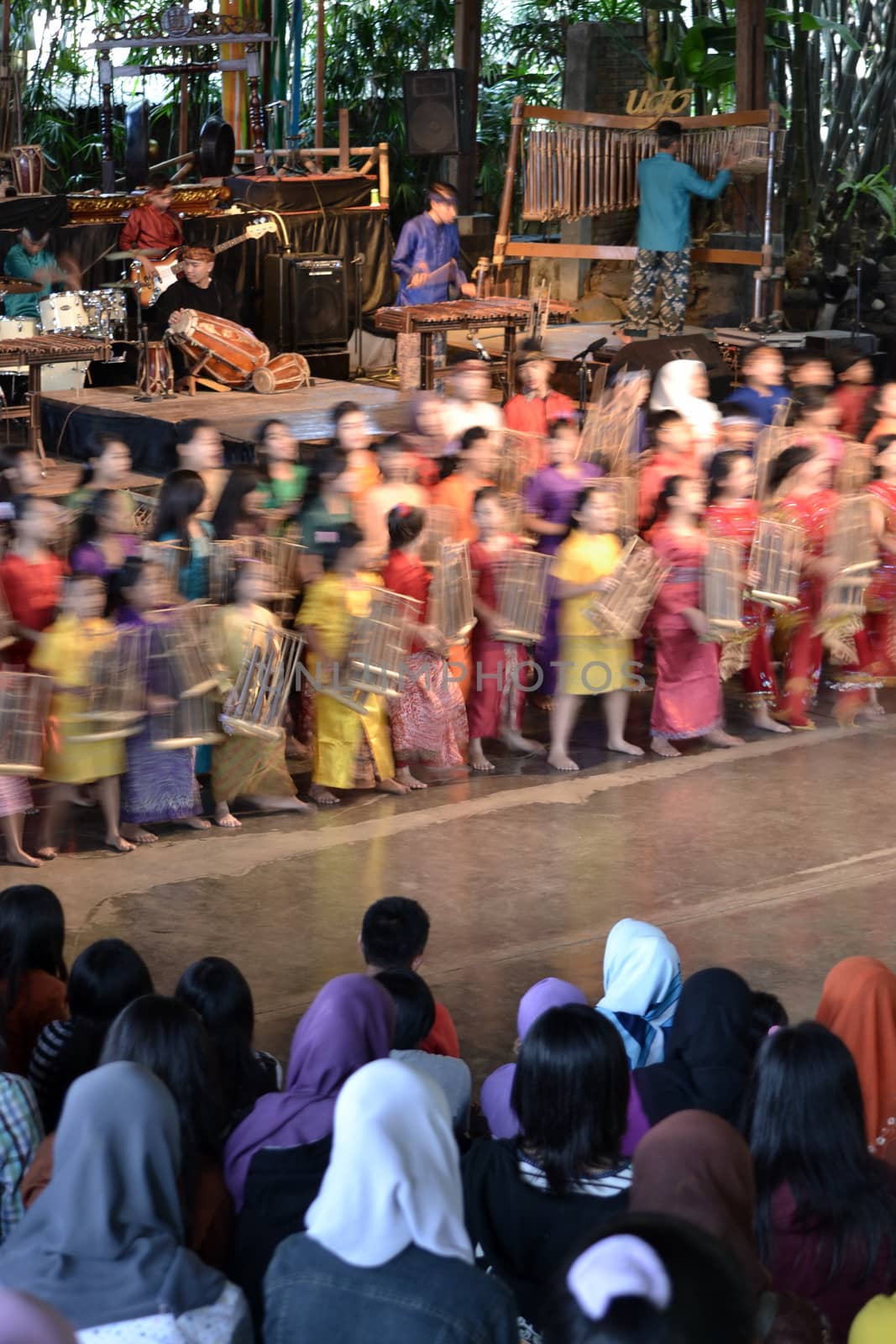 bandung, indonesia-june 16, 2014: kids playing angklung at saung angklung udjo. angklung is traditional musical heritage made from bamboo and worldwide recognize originally from indonesia.