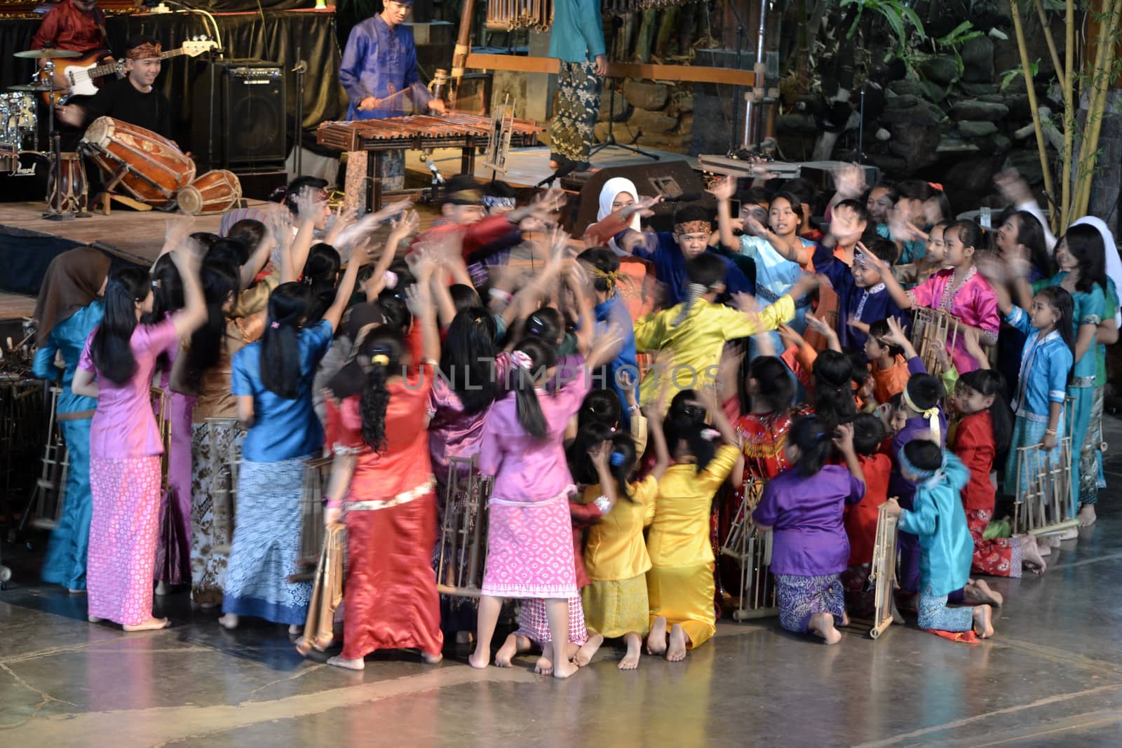 bandung, indonesia-june 16, 2014: kids playing angklung at saung angklung udjo. angklung is traditional musical heritage made from bamboo and worldwide recognize originally from indonesia.