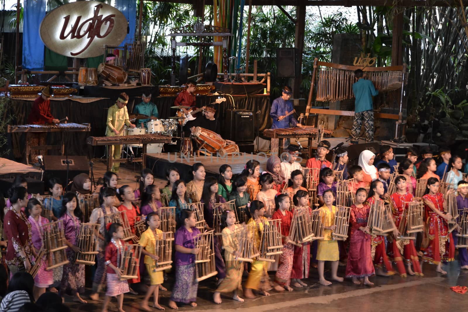 bandung, indonesia-june 16, 2014: kids playing angklung at saung angklung udjo. angklung is traditional musical heritage made from bamboo and worldwide recognize originally from indonesia.