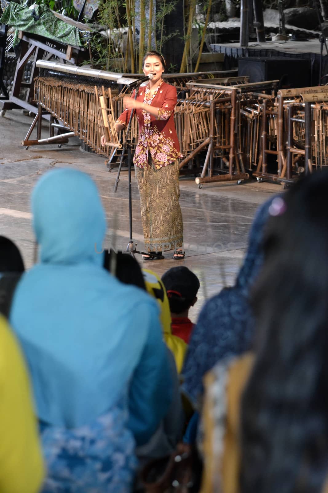 bandung, indonesia-june 16, 2014: beautiful lady as master of ceremony in saung angklung udjo choir.