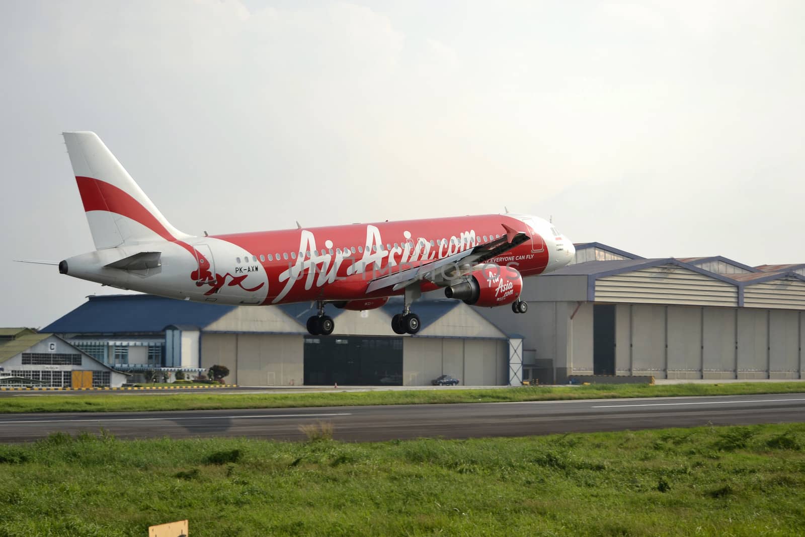 bandung, indonesia-june 16, 2014: Air Asia airplane taking manoeuvre on husein sastranegara airport bandung.
