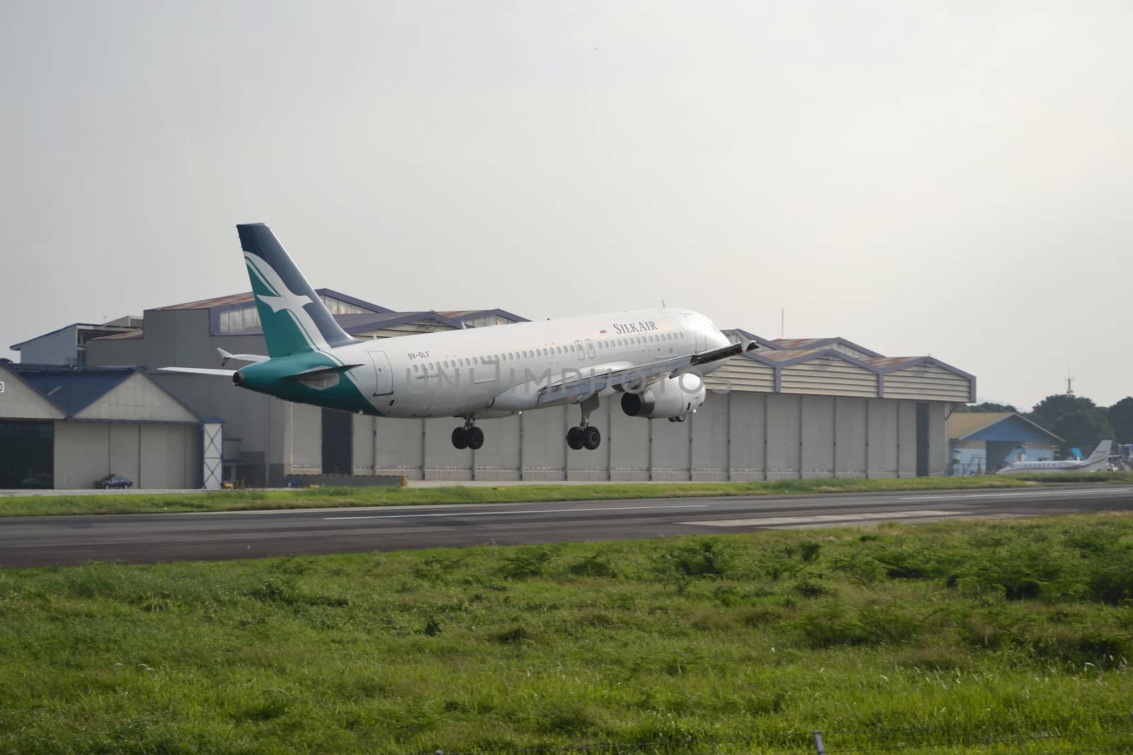 bandung, indonesia-june 16, 2014: Silk Air airplane taking manoeuvre on husein sastranegara airport bandung.