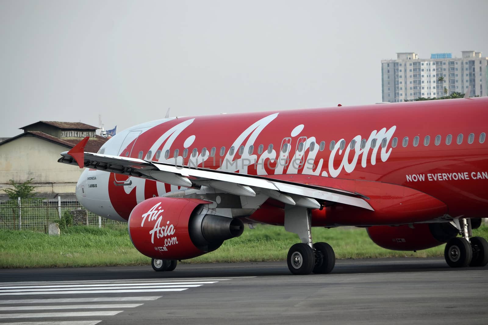 bandung, indonesia-june 16, 2014: Air Asia airplane taking manoeuvre on husein sastranegara airport bandung.