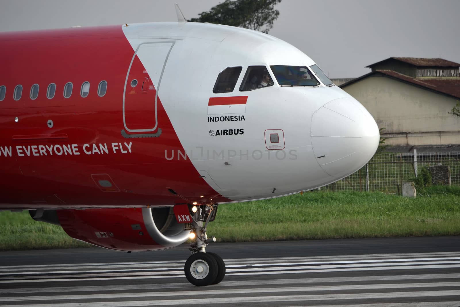 bandung, indonesia-june 16, 2014: Air Asia airplane taking manoeuvre on husein sastranegara airport bandung.