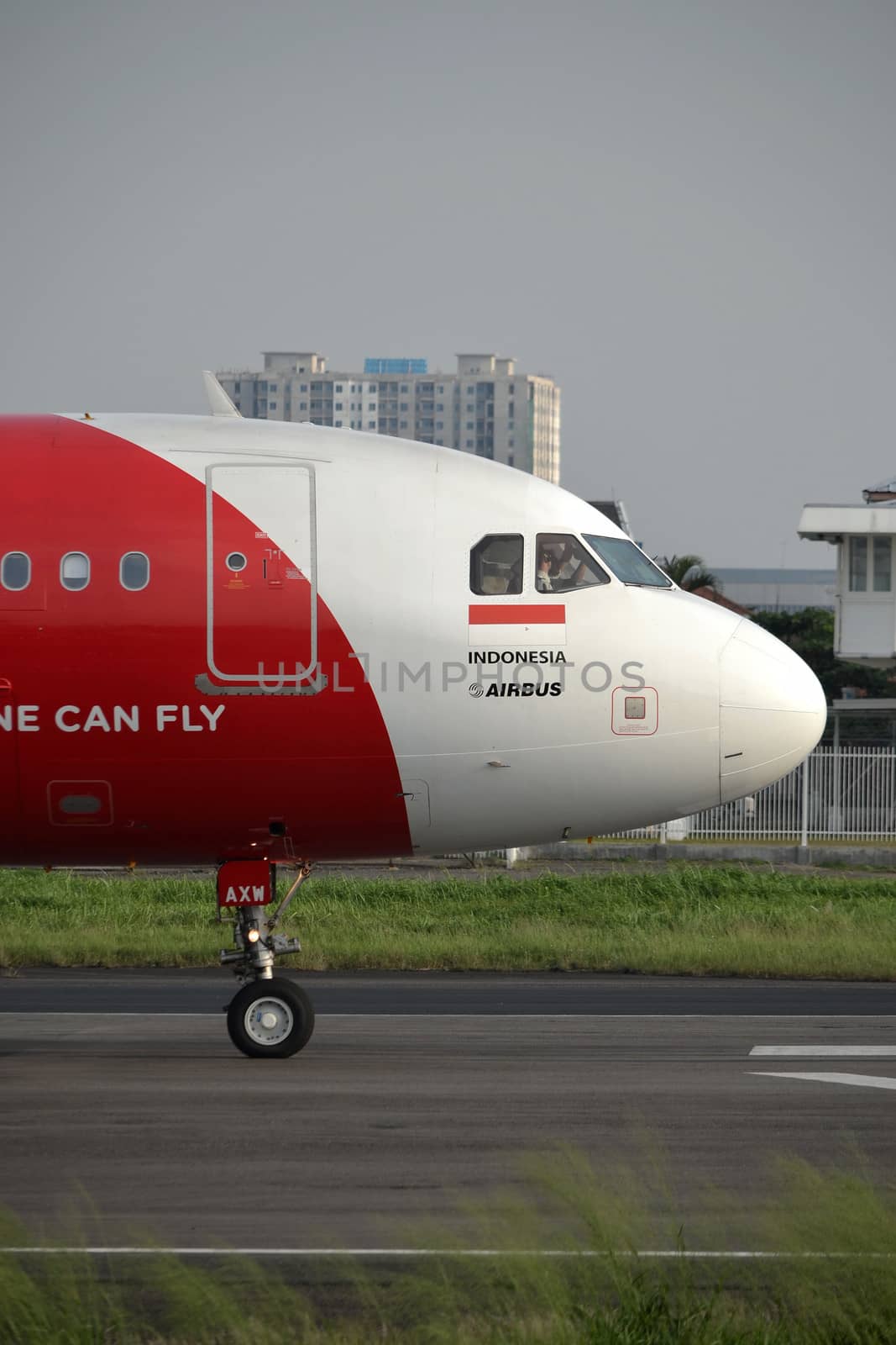 bandung, indonesia-june 16, 2014: Air Asia airplane taking manoeuvre on husein sastranegara airport bandung.
