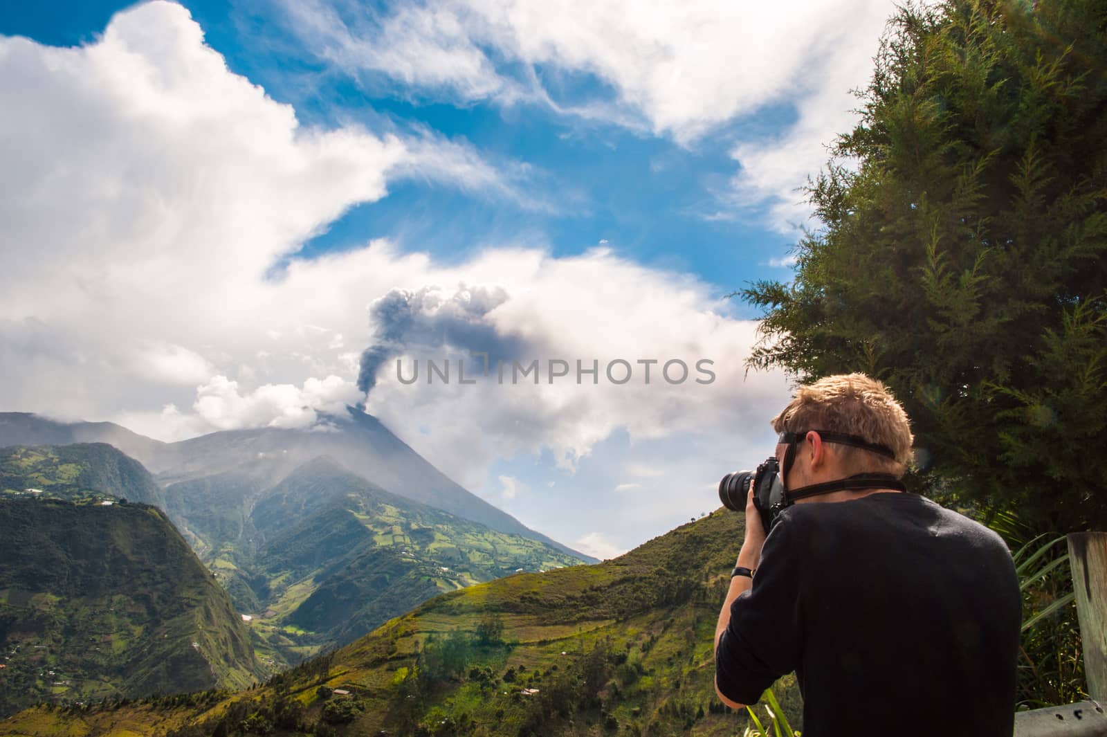 BANOS, DECEMBER 10: Unrecognizable brave photographer  in a gas mask takes pictures of Tungurahua volcanic eruption - december 10, 2010 in Banos, Cordillera Occidental of the Andes of central Ecuador, South America 