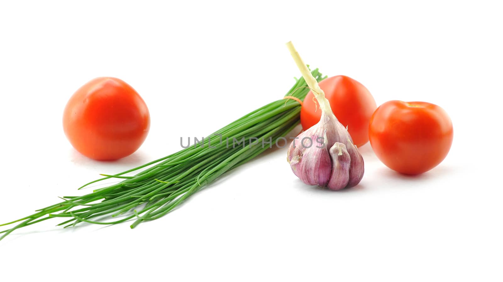 Mediterranean food ingredients: spring onions, garlic and tomatoes