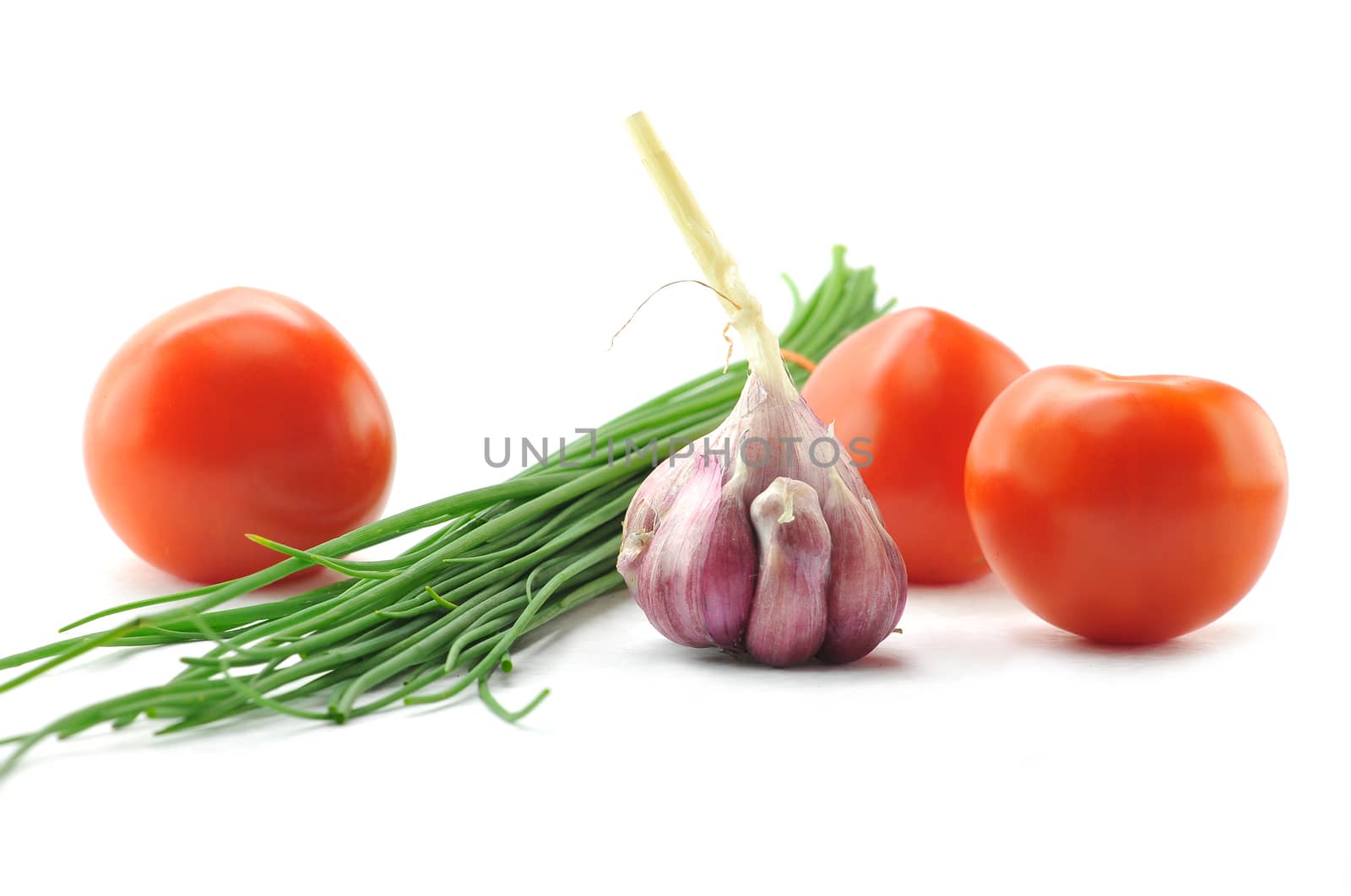 Mediterranean food ingredients: spring onions, garlic and tomatoes