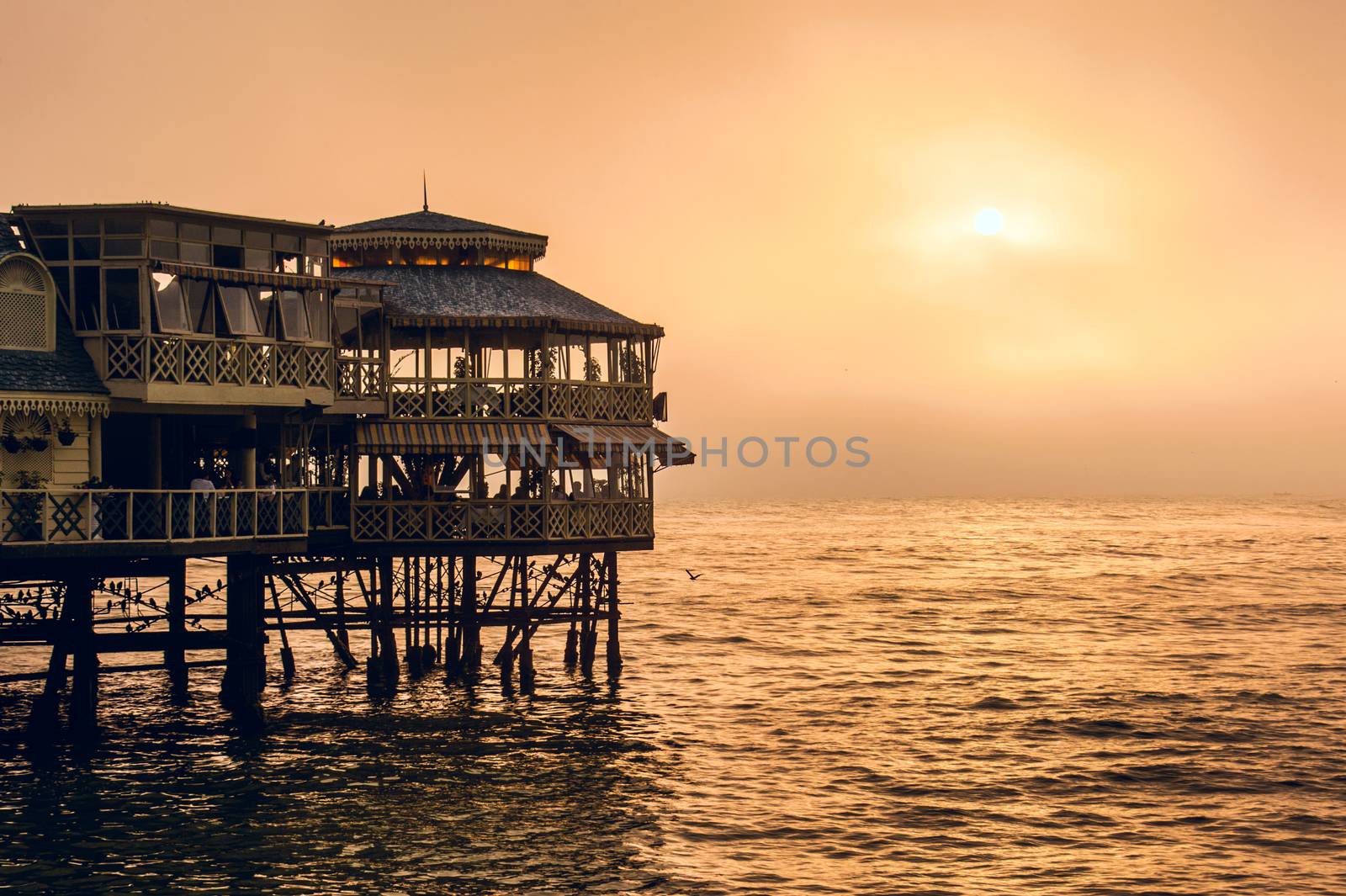 Evening Lima. Sunset on the Pacific Ocean, the sun breaks through the mist. Peru, Latin America