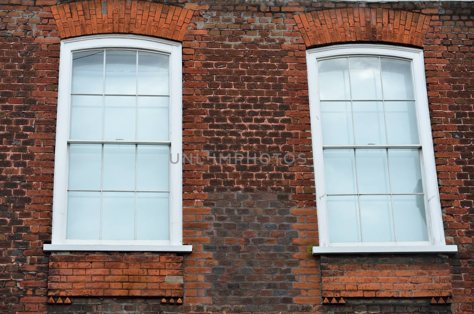 Two windows in brick wall by pauws99