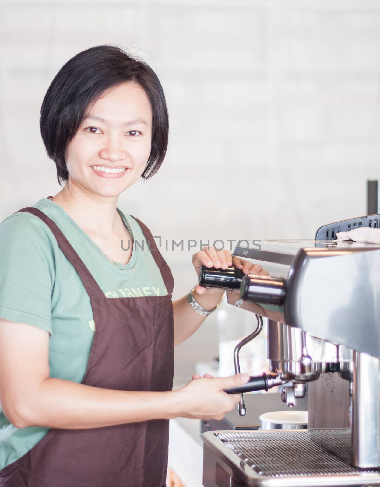Woman barista enjoy at work by punsayaporn