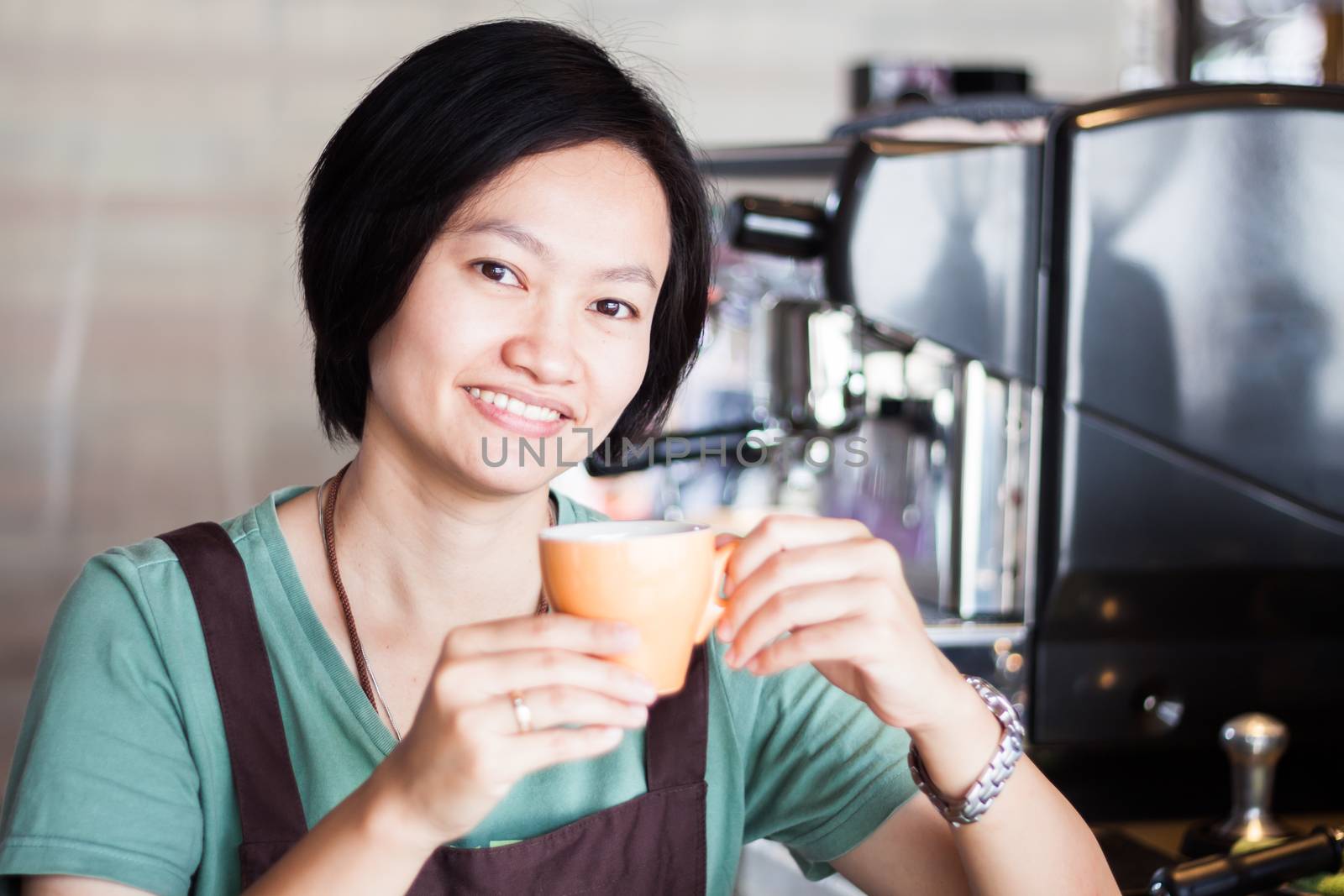 Asian barista enjoy her coffee, stock photo