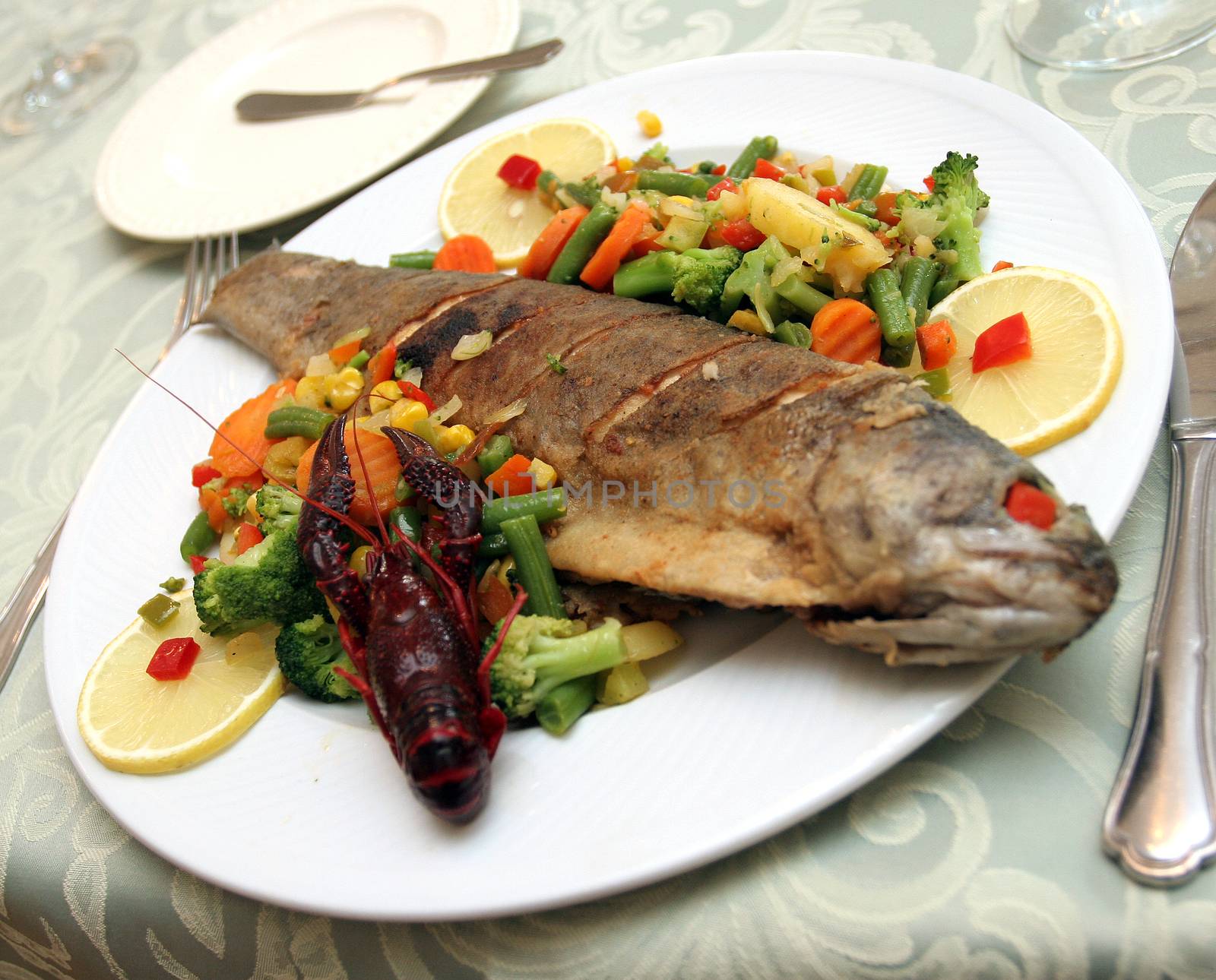 Fried trout with vegetables. by robert_przybysz