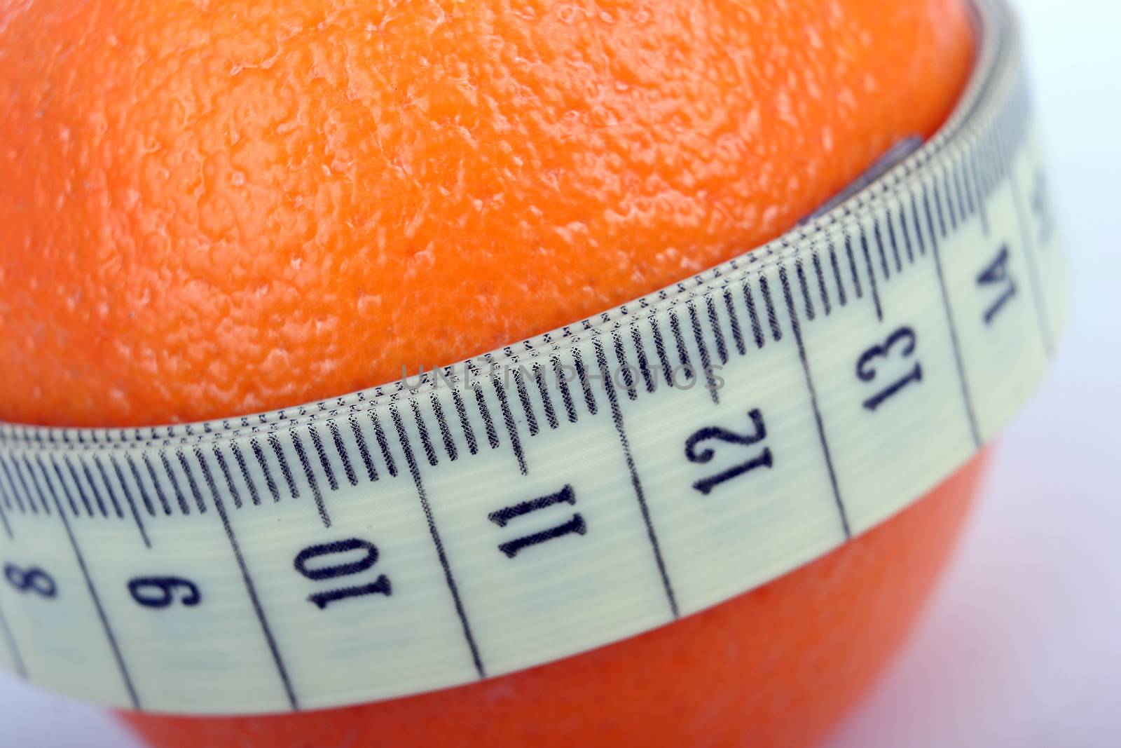 Supple orange with a tape measure - symbol of the fight against cellulite.