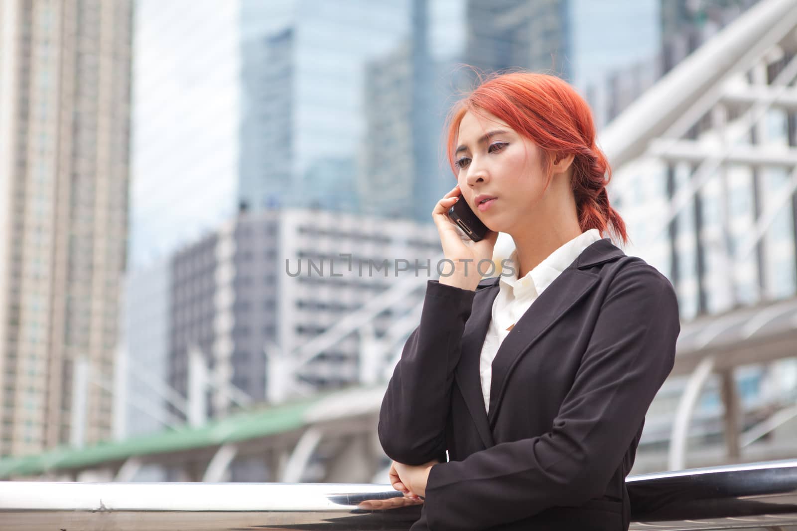 Young business asian woman calling on the phone at modern city