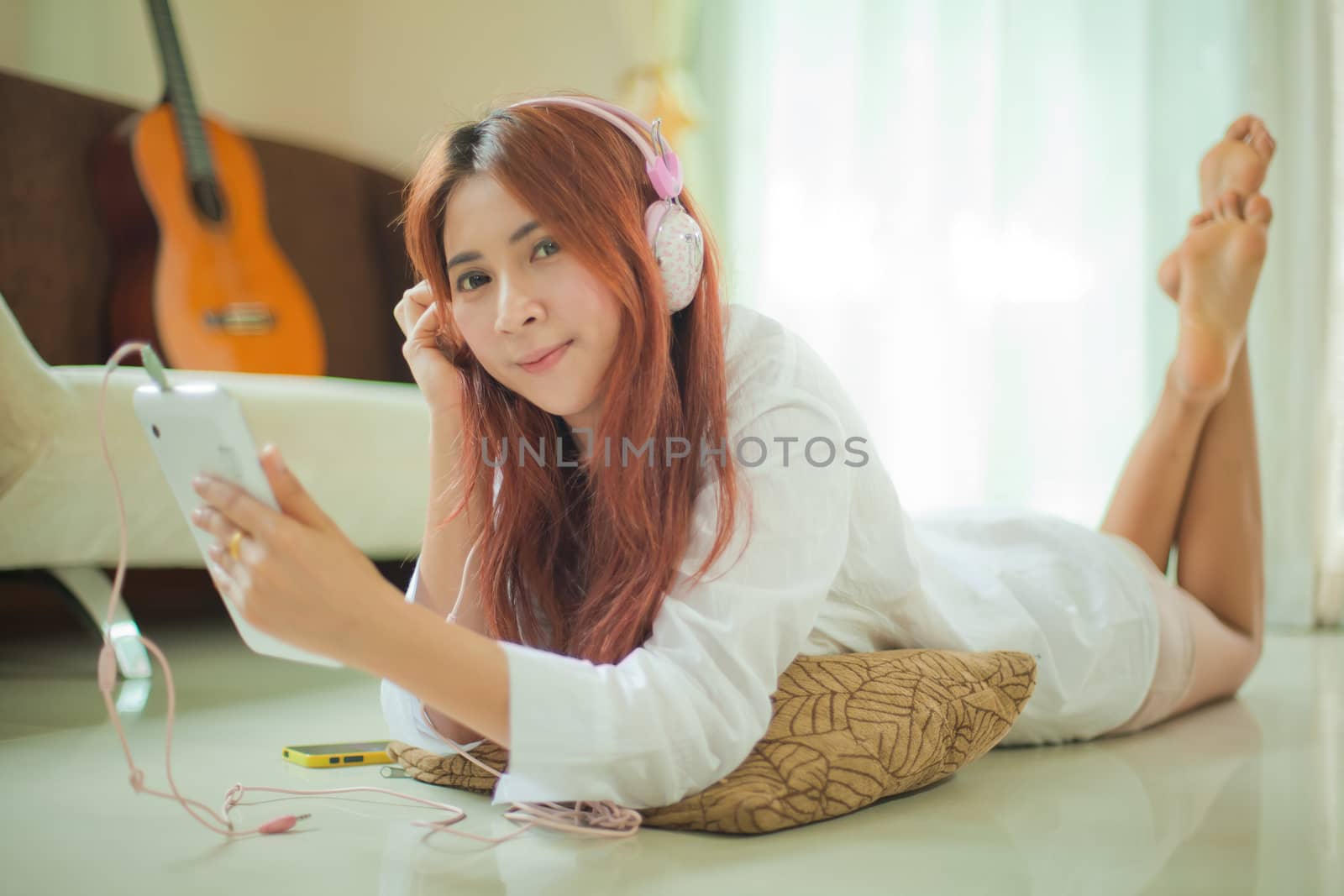 Young asian beautiful woman with smart phone and listening to music