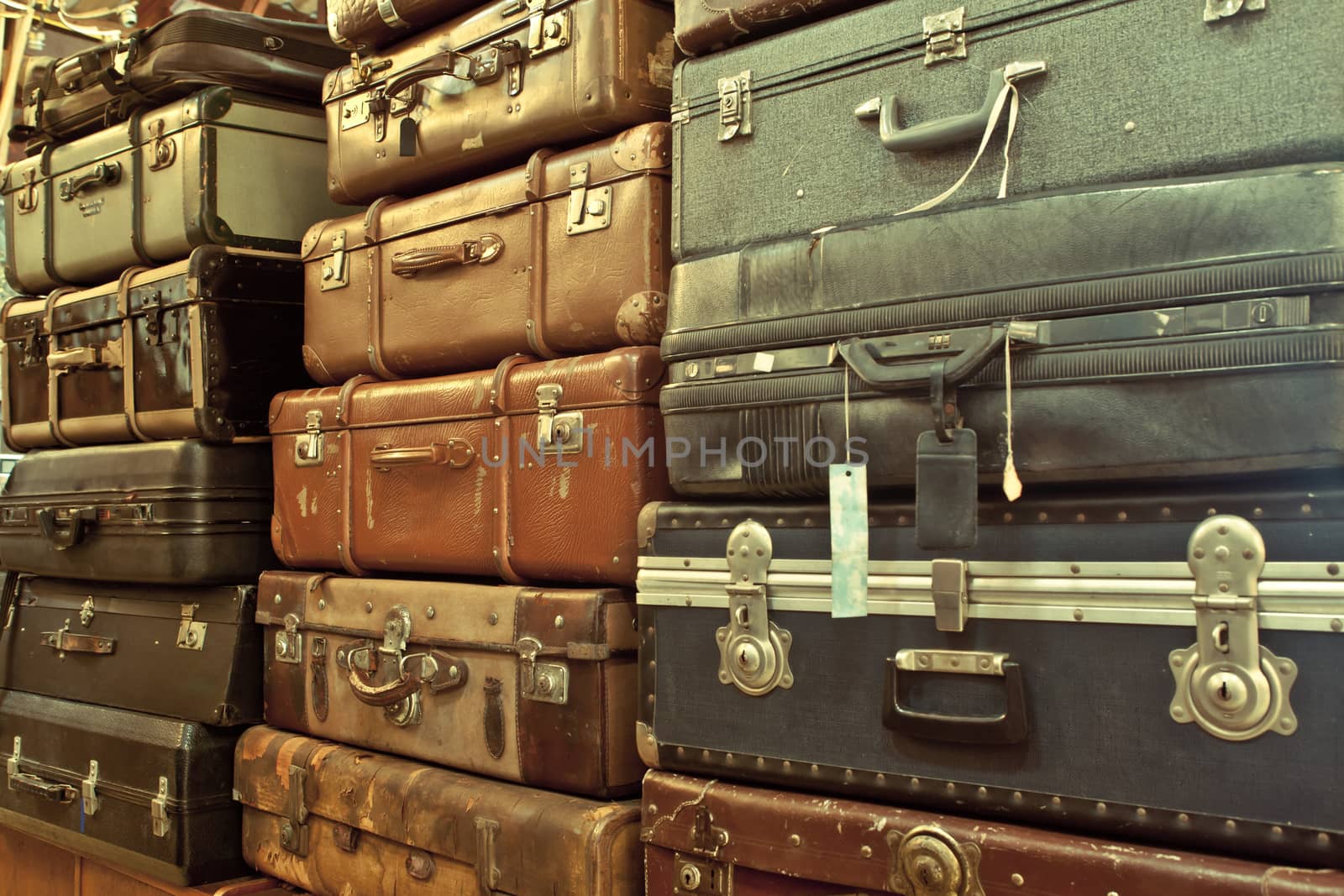 leather suitcases stacked by witthaya