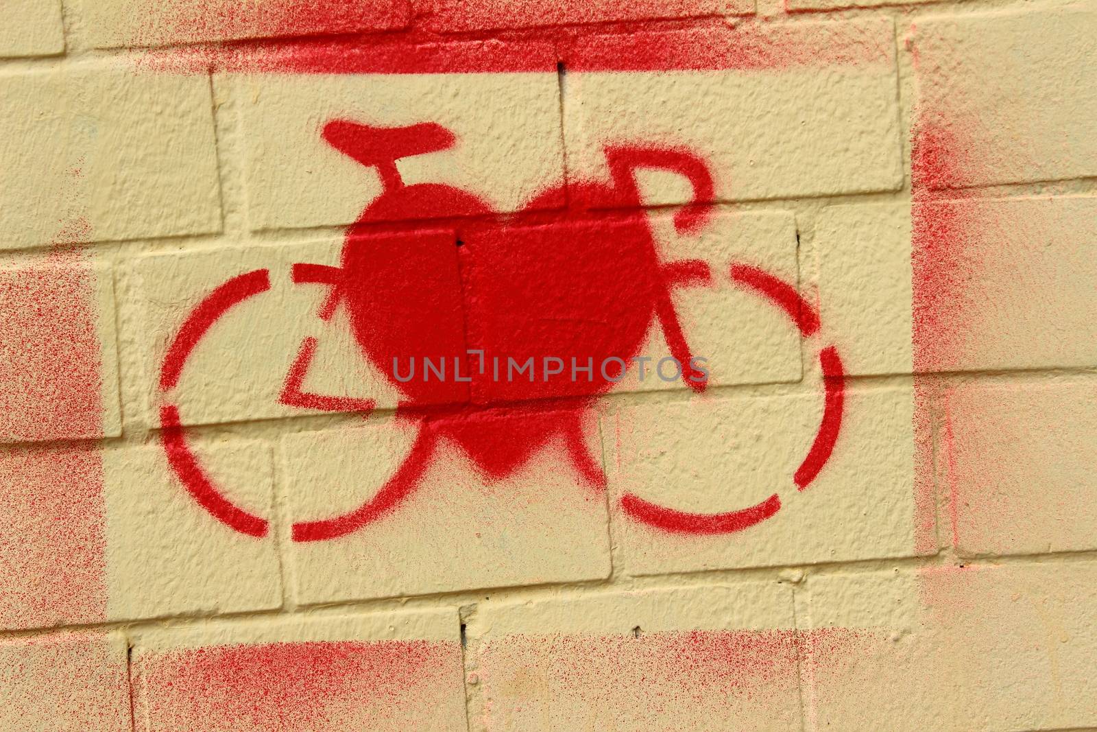 On the bright red paint wall painted bike and heart