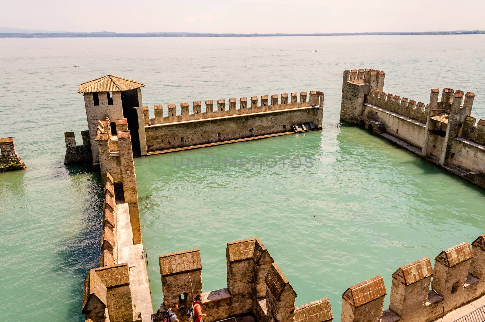 SIRMIONE, ITALY - JUNE 1, 2014: The Scaliger Castle in Sirmione, Italy, June 1, 2014. Surrounded by the water, the Scaliger Castle is considered one of the finest examples of medieval fortification.
