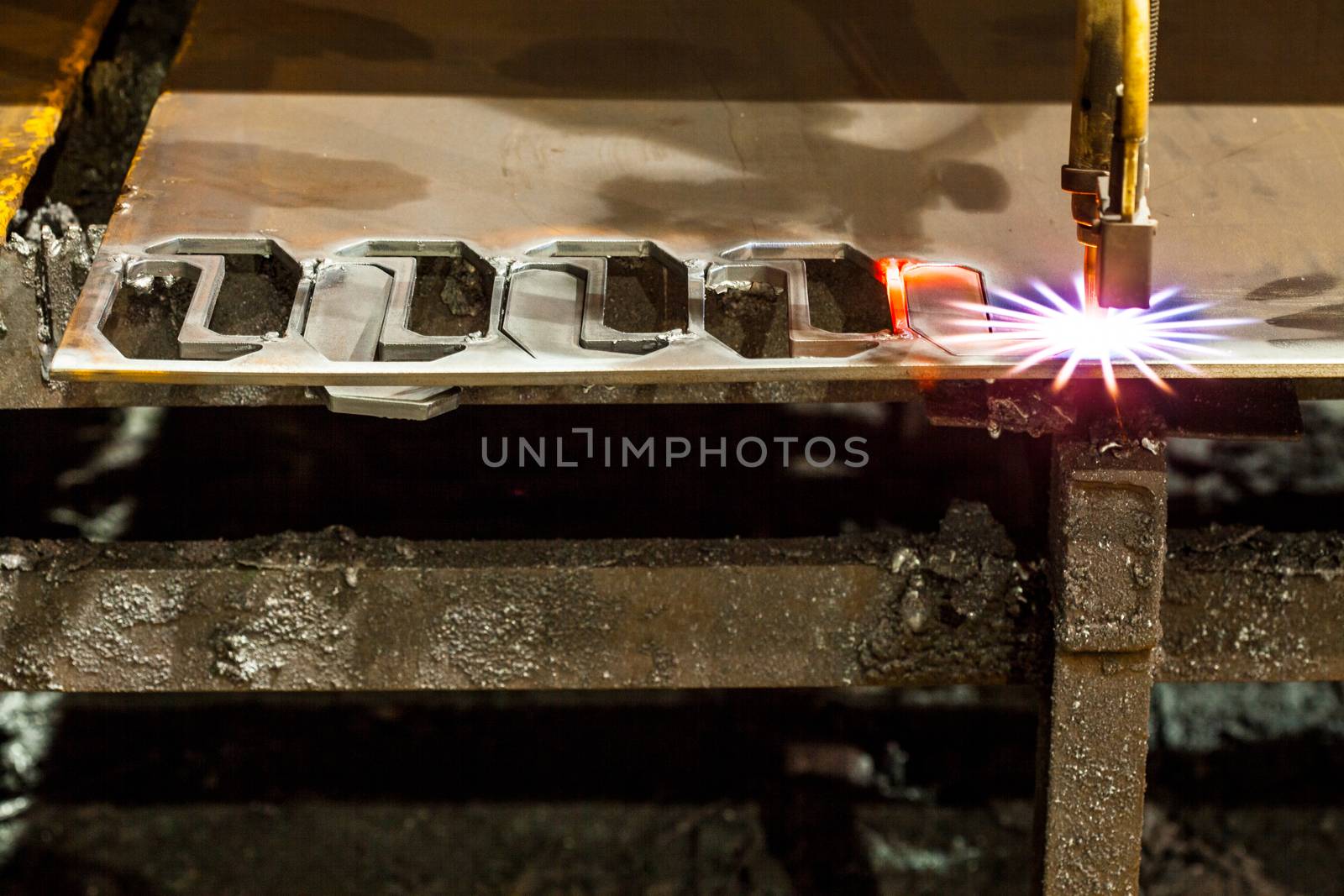 Laser Cutting Machine of metal sheet with sparks.