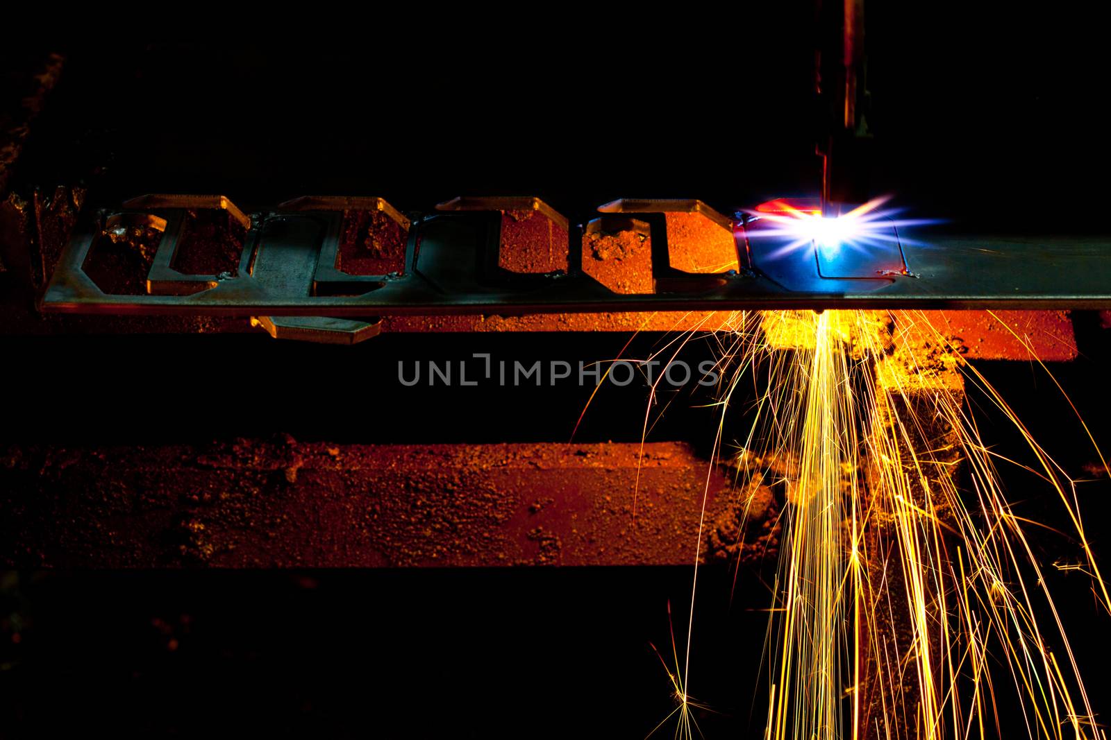 Laser Cutting Machine of metal sheet with sparks.