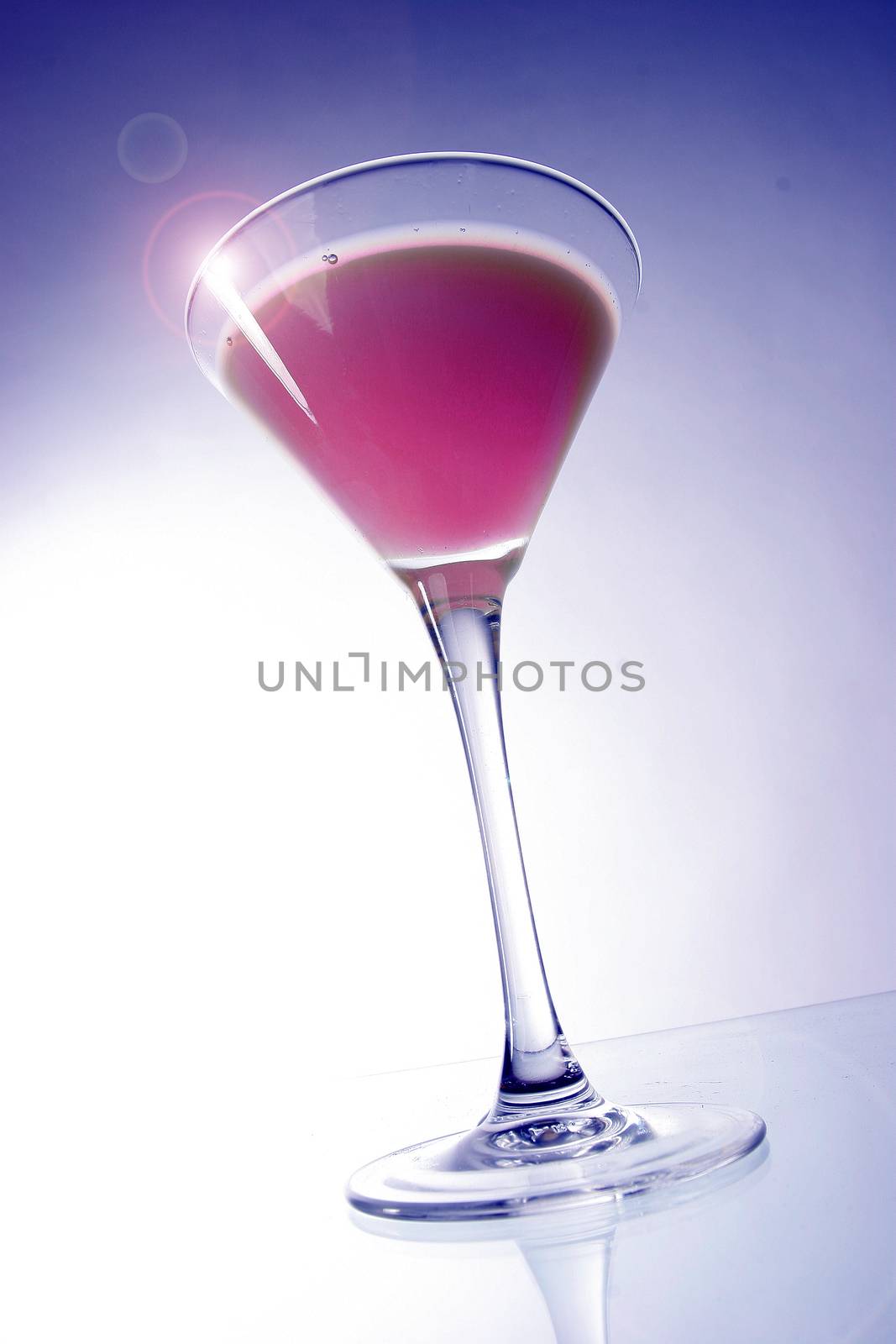 Colored drink in a glass for cocktails