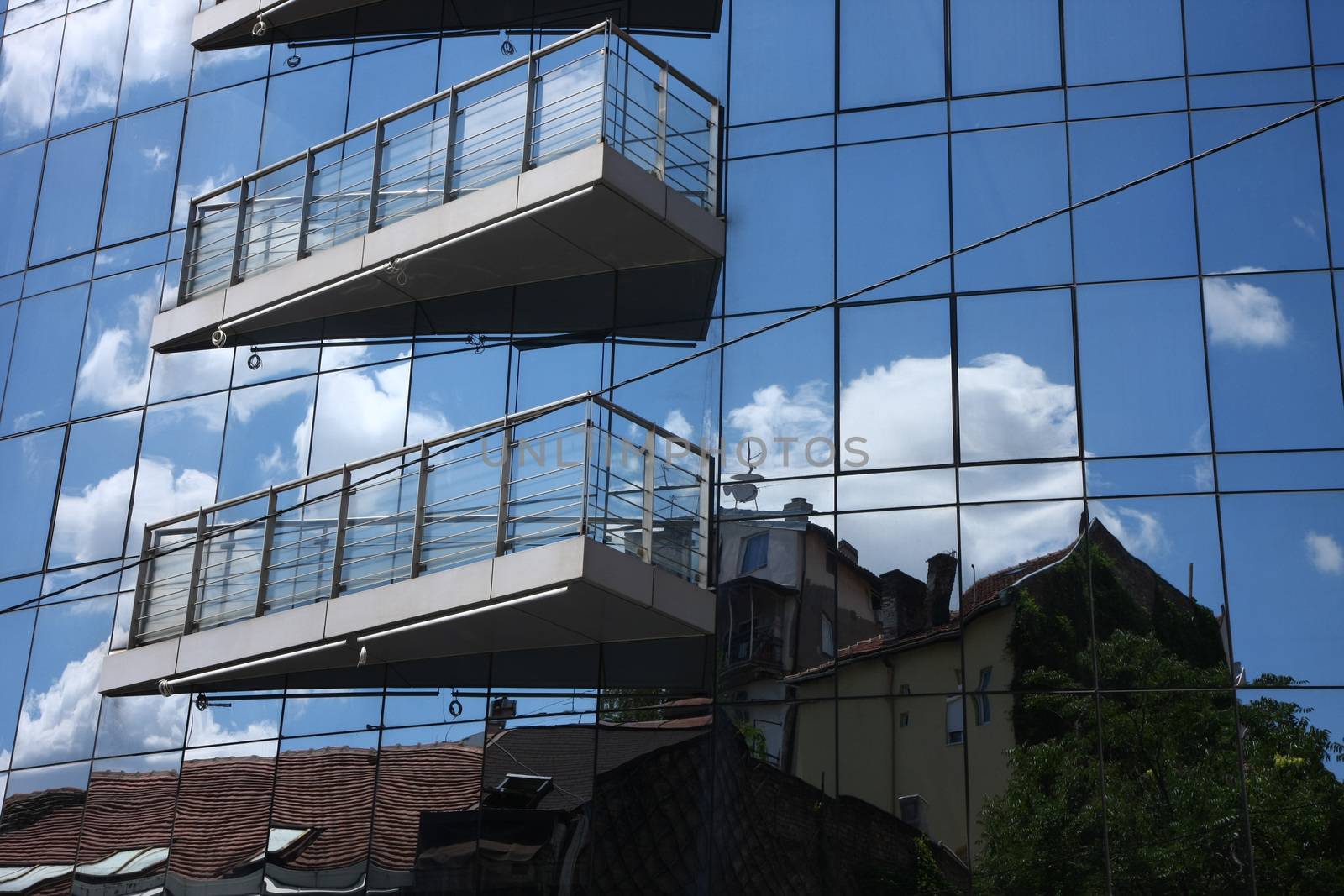 Reflection of old hauses and sky in the modern glass huose in Belgrade,Serbia
