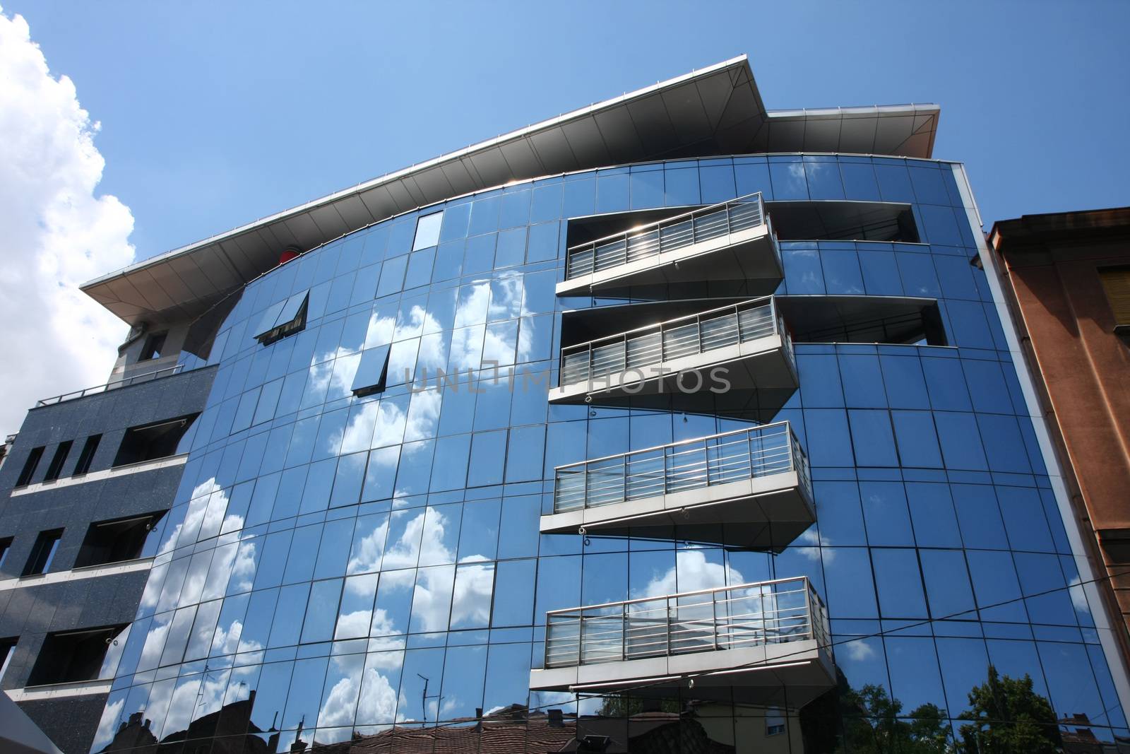 Reflection of old hauses and sky in the modern glass huose in Belgrade,Serbia