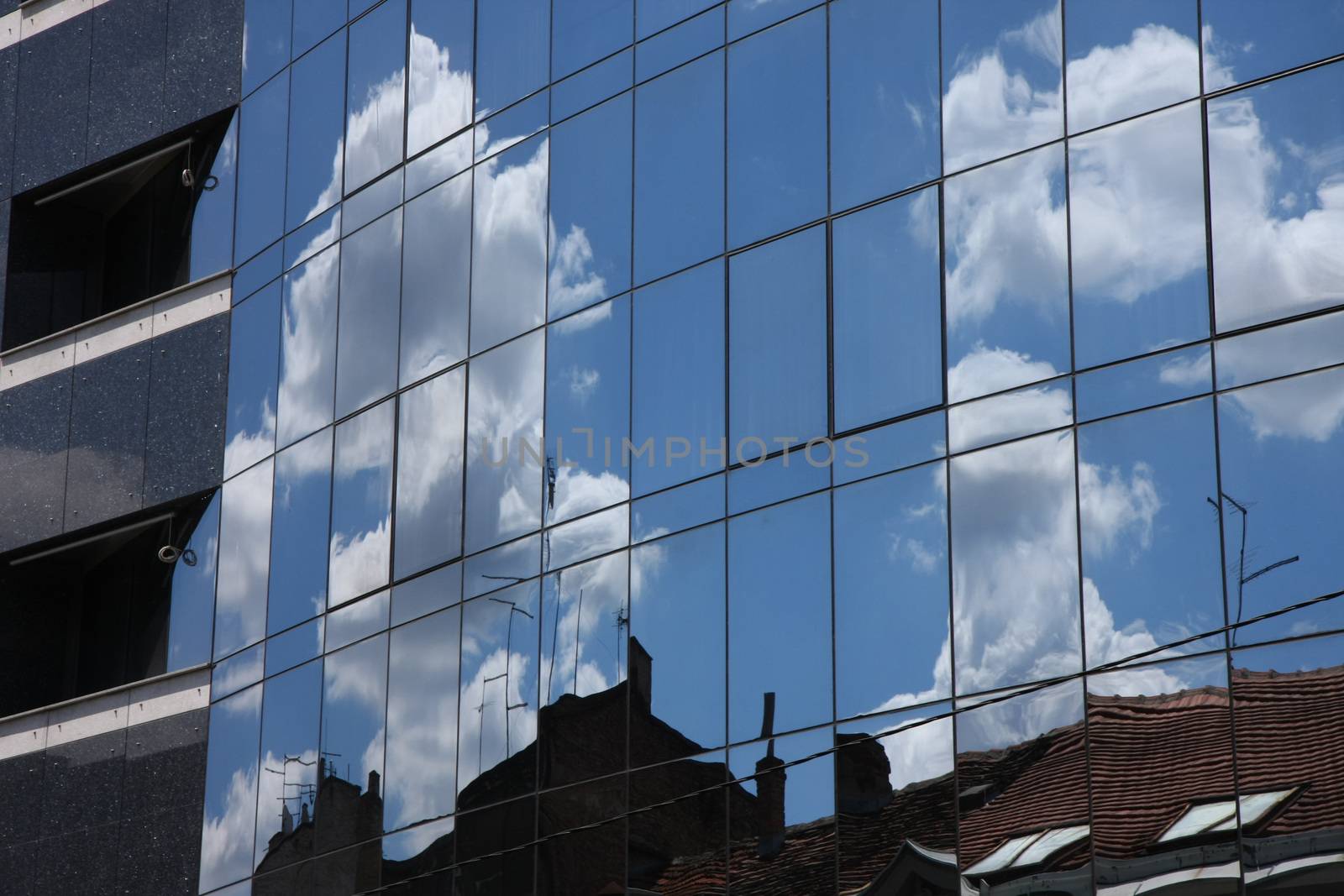 Reflection of old hauses and sky in the modern glass huose in Belgrade,Serbia