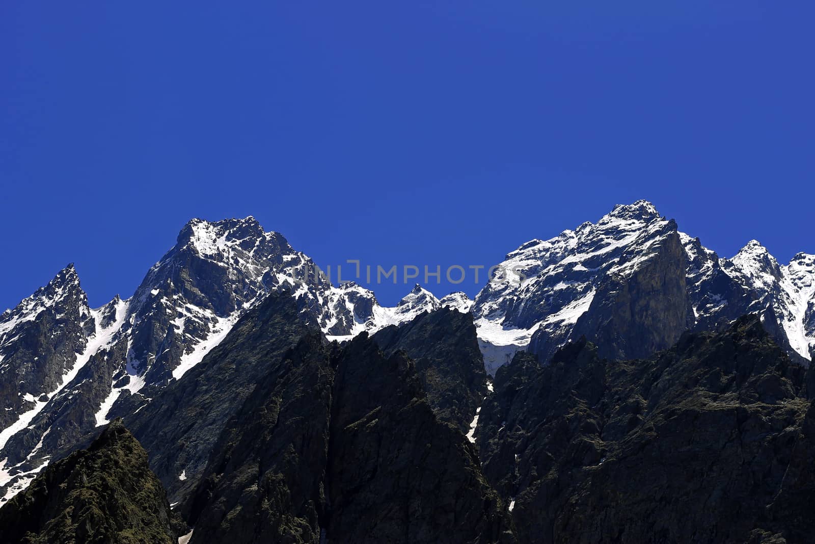 Caucasus mountains under snow and clear blue sky