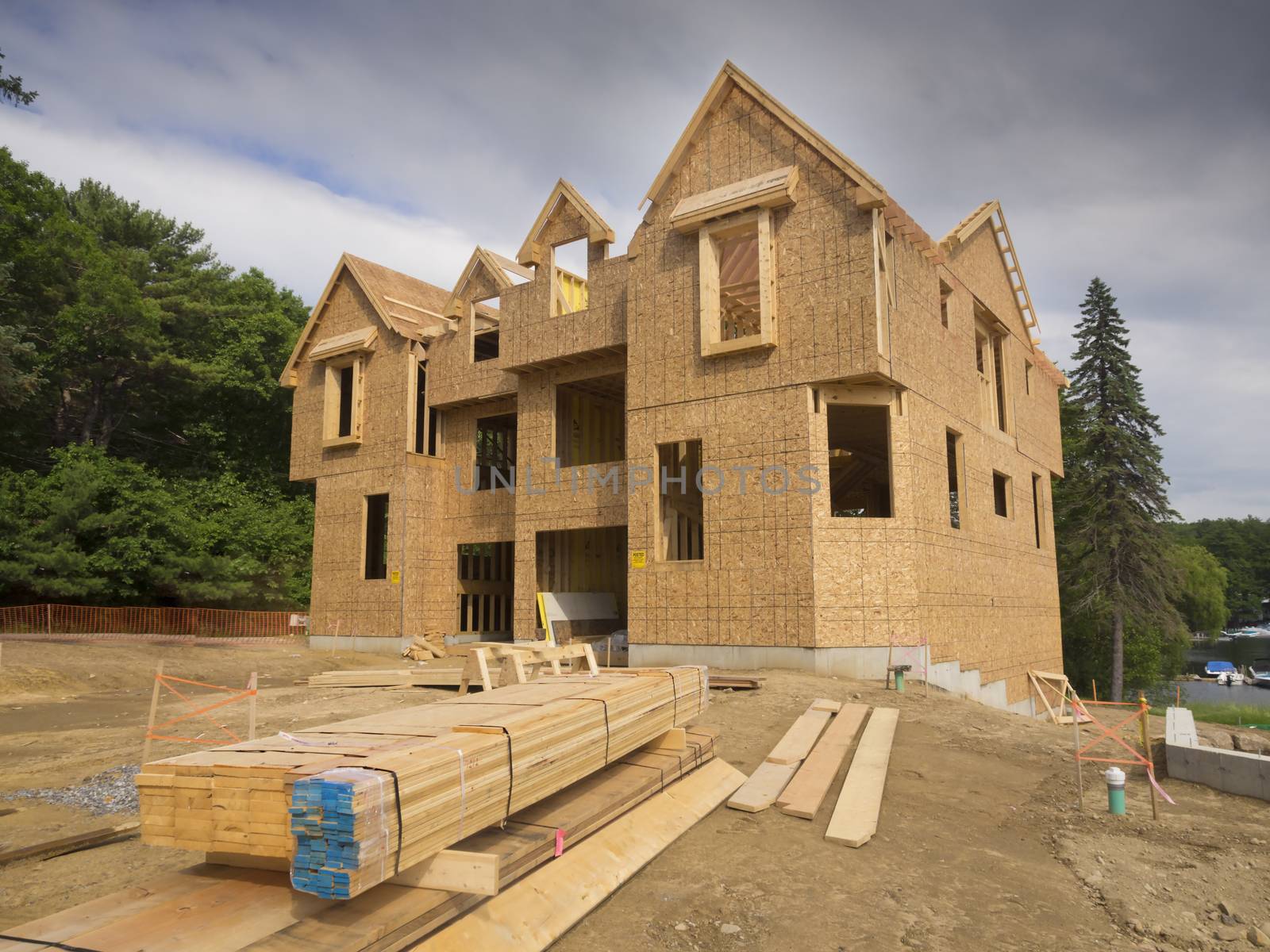 A single family home under construction. The house has been framed and covered in plywood