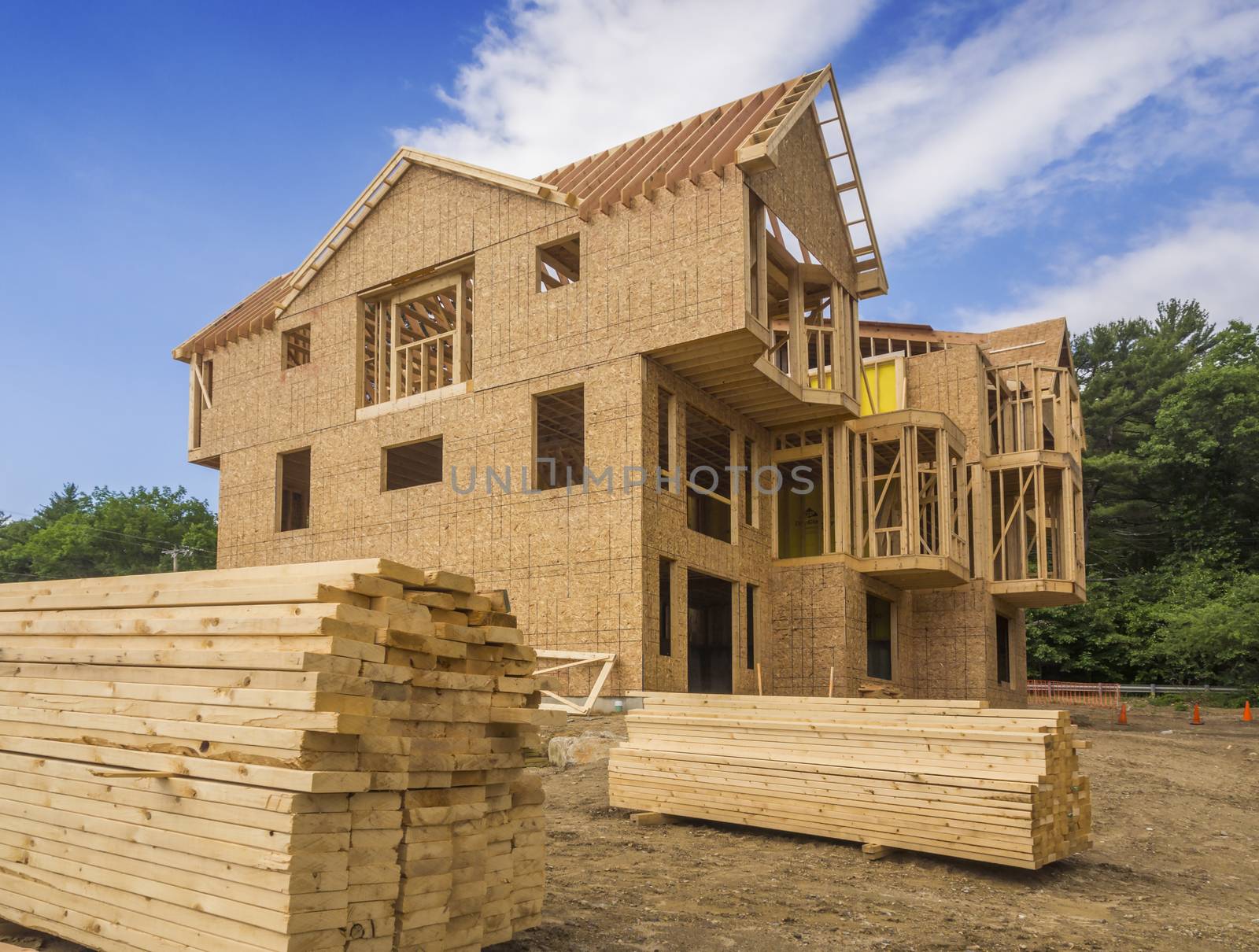 A single family home under construction. The house has been framed and covered in plywood