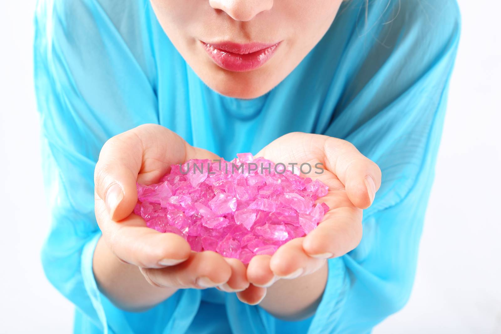 Well groomed female hands they keep pink, pastel crystals by robert_przybysz