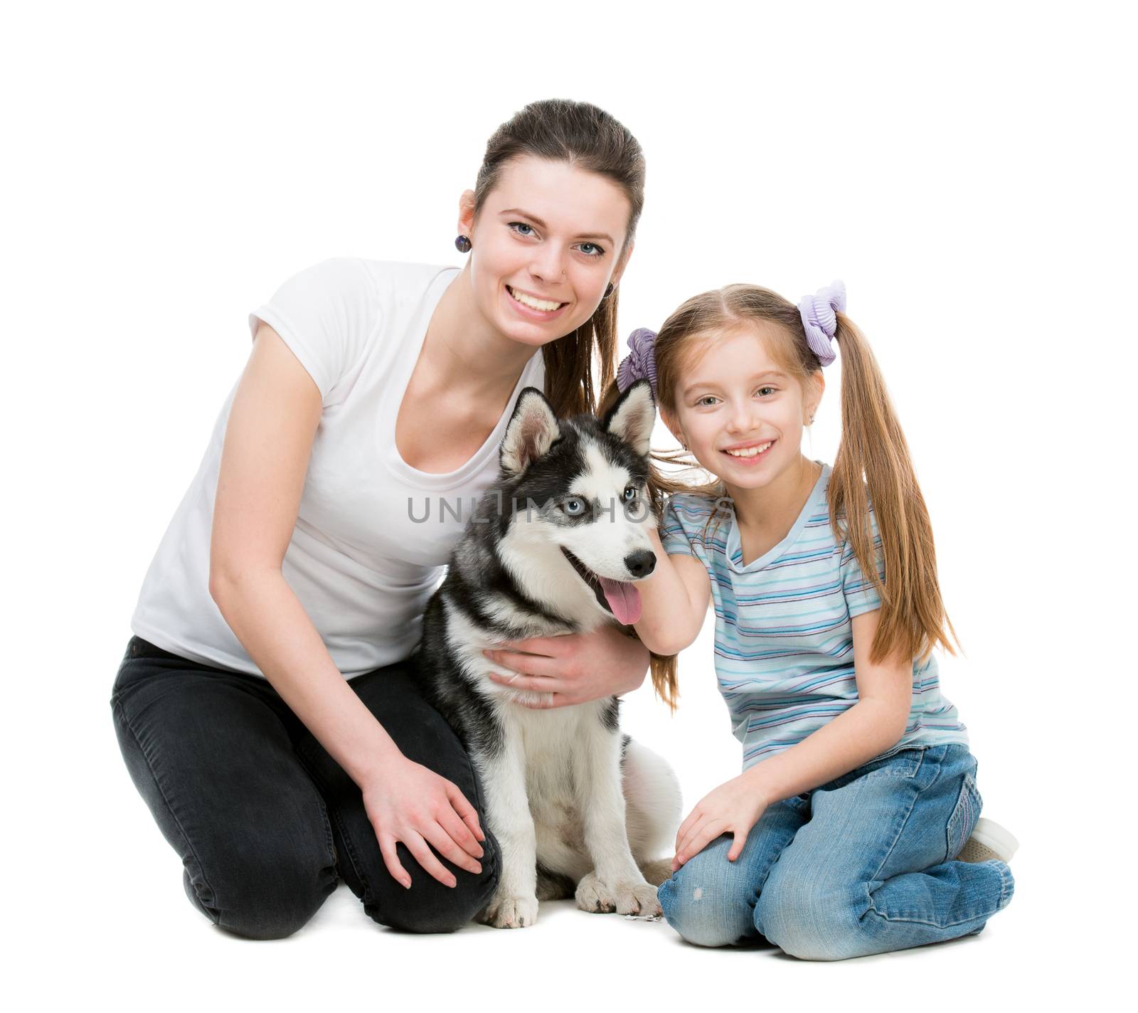 two sisters and a husky dog sitting on the floor on a white background