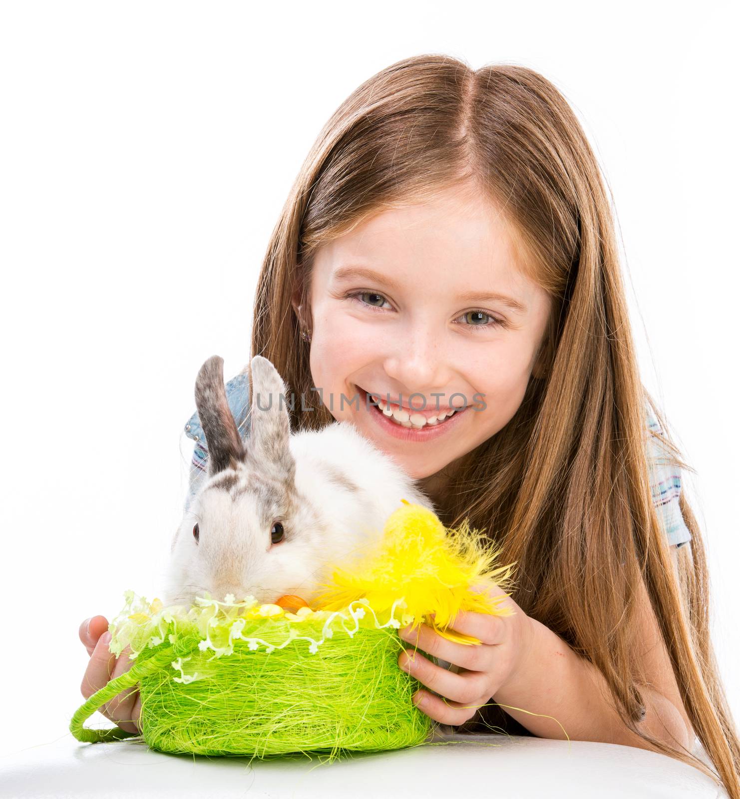 cute little girl with white Easter bunny in a basket
