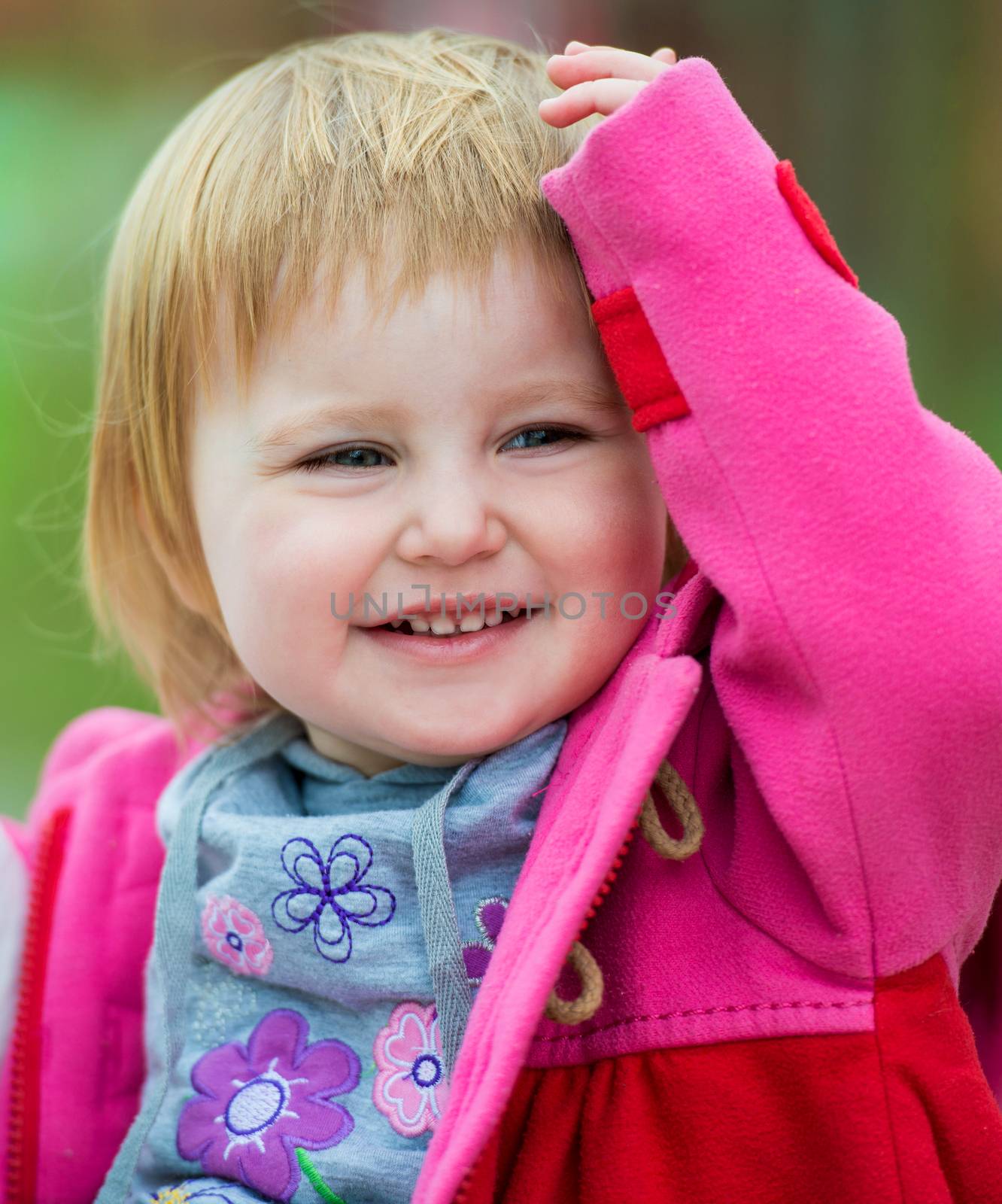 portrait of cute smiling little girl outdoors