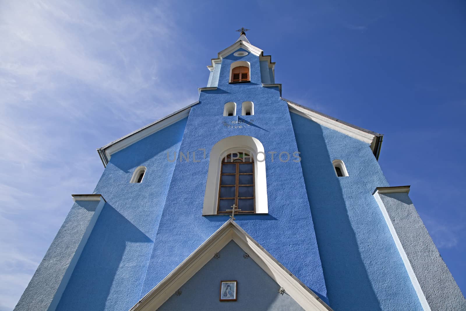 Catholic church against blue sky, view from below