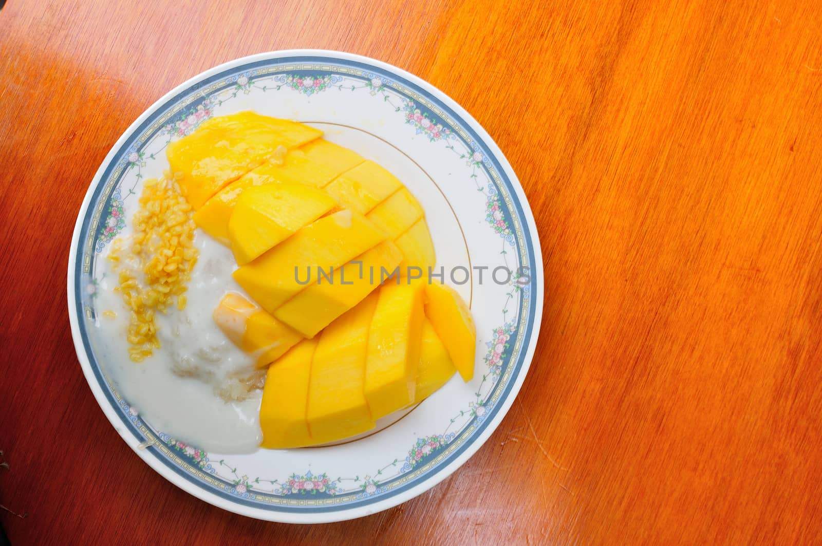 Thai style tropical dessert, glutinous rice eat with mangoes by thampapon