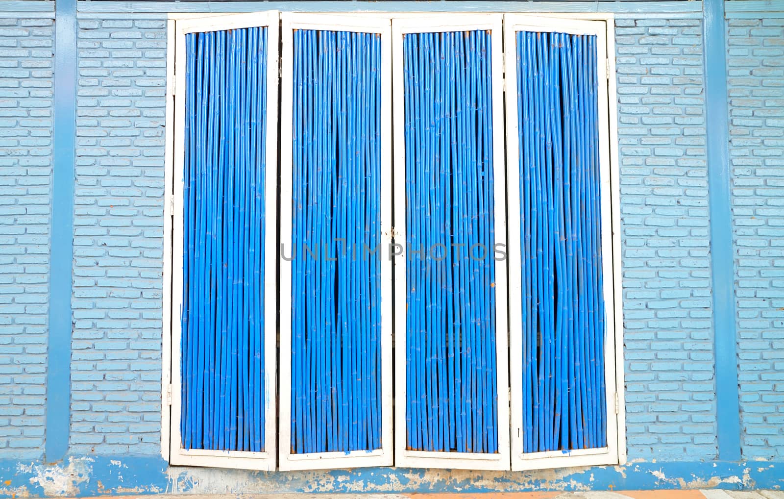 Blue and White Wooden Door with Blue brick wall