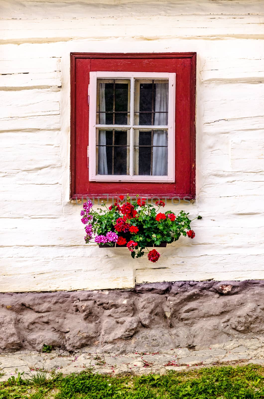 Detail of colorful window on old traditional house, Vlkolinec village, Slovakia