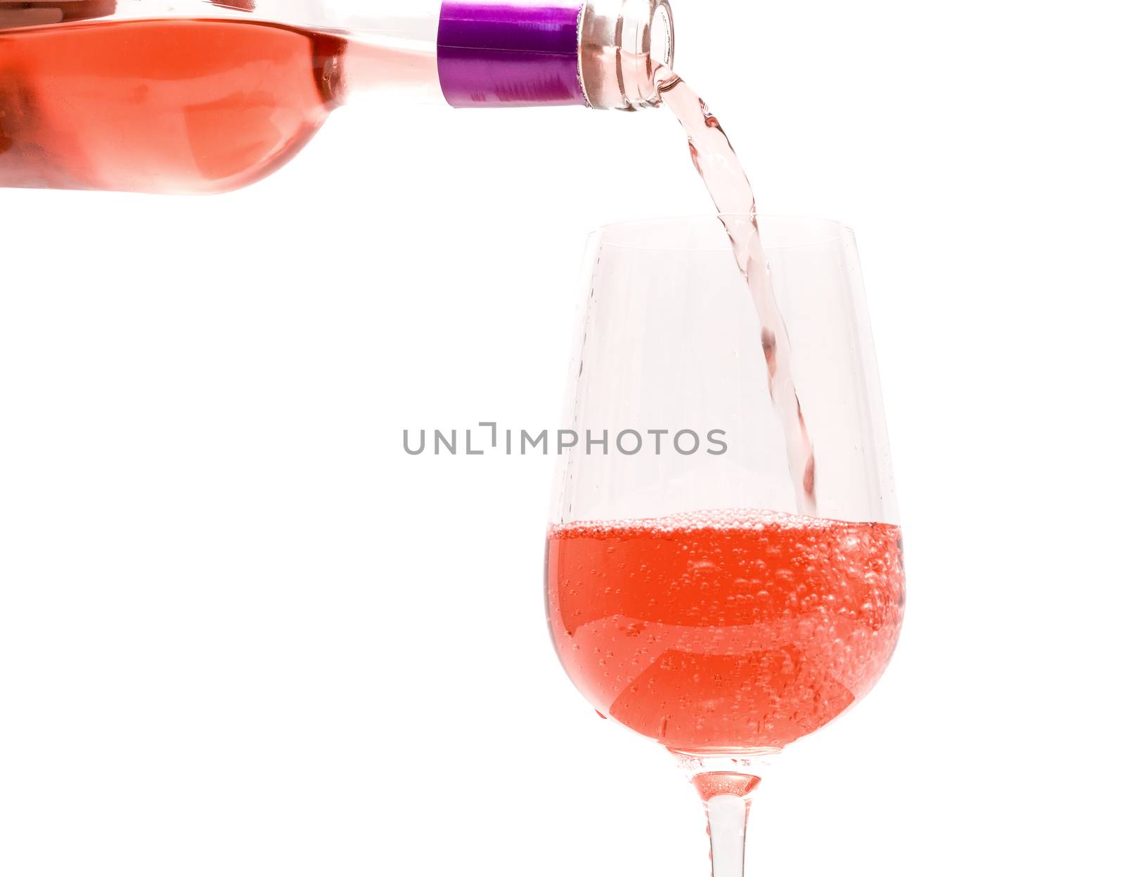 Pink Wine Pouring into Glass, on white background