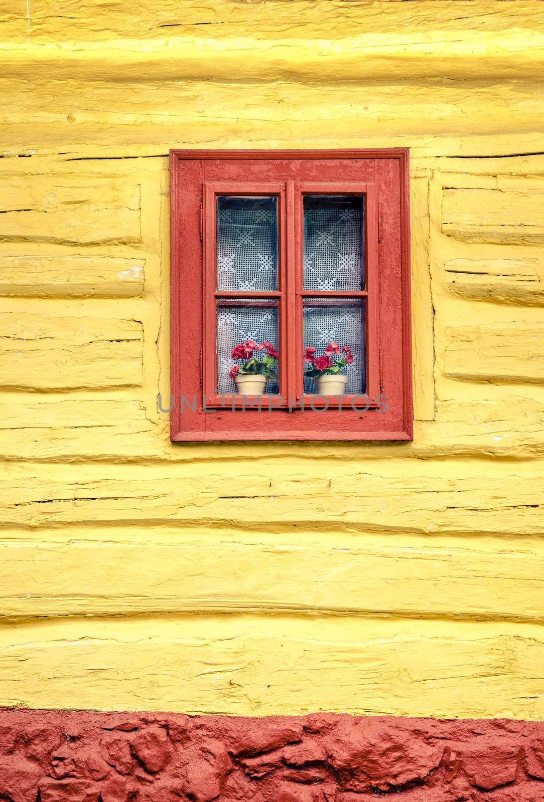 Close-up detail of colorful window on wooden cottage by martinm303
