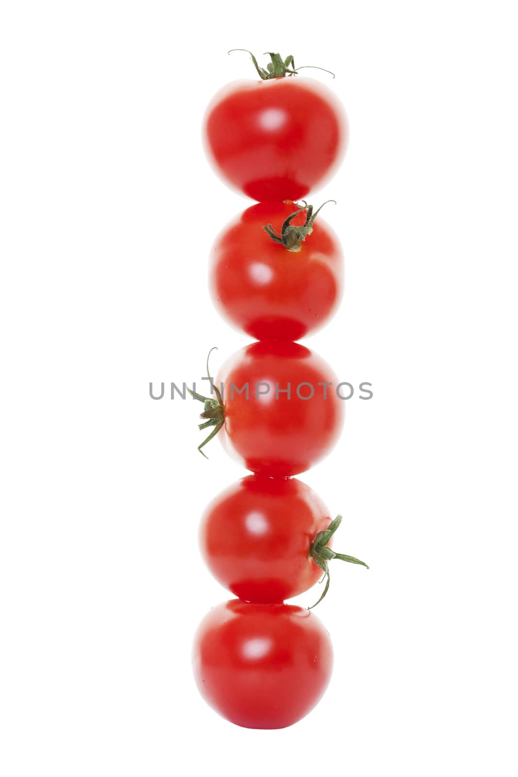 Five tomatoes stacked on white background.