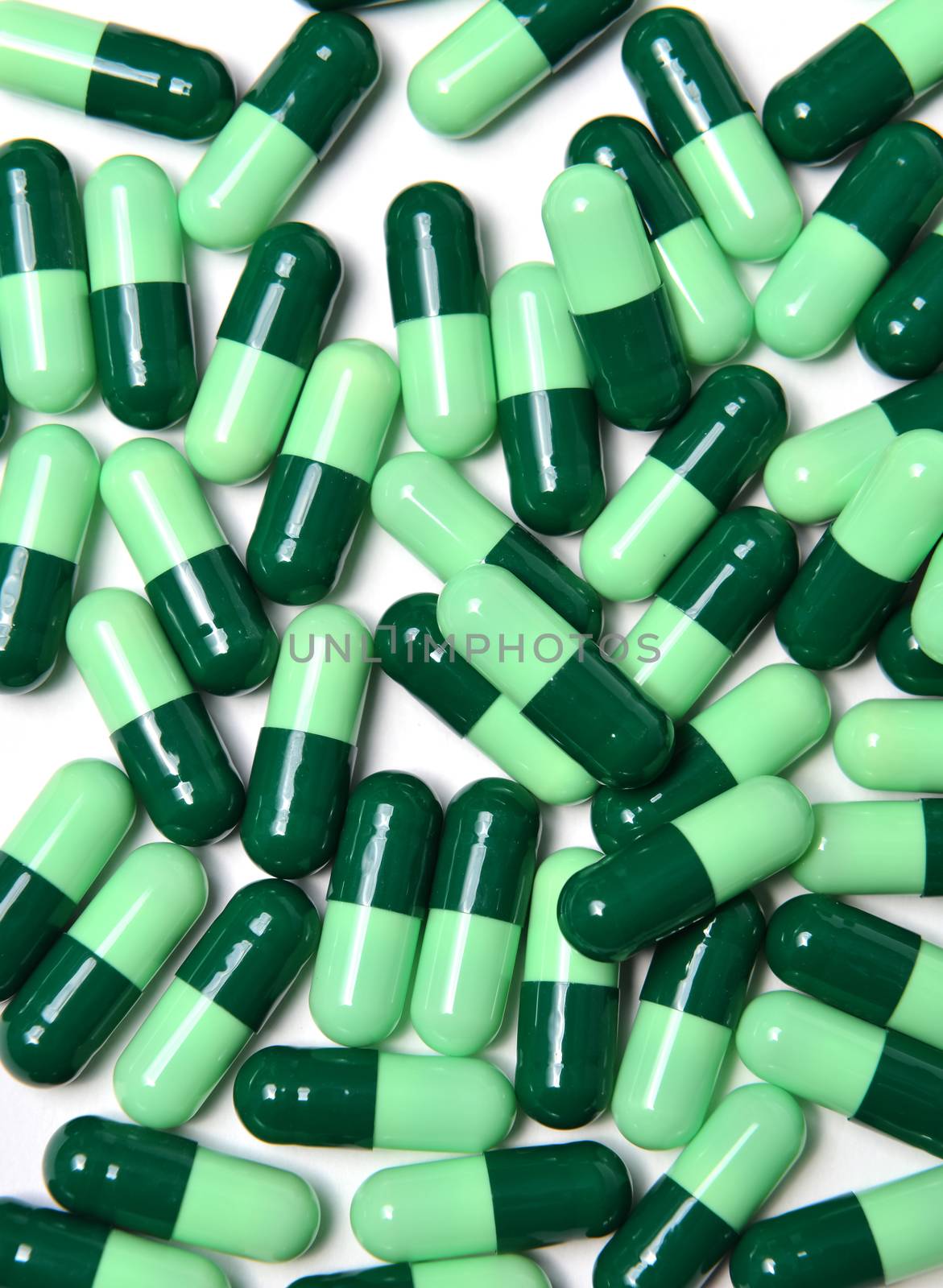 group of green capsule medicine on white background