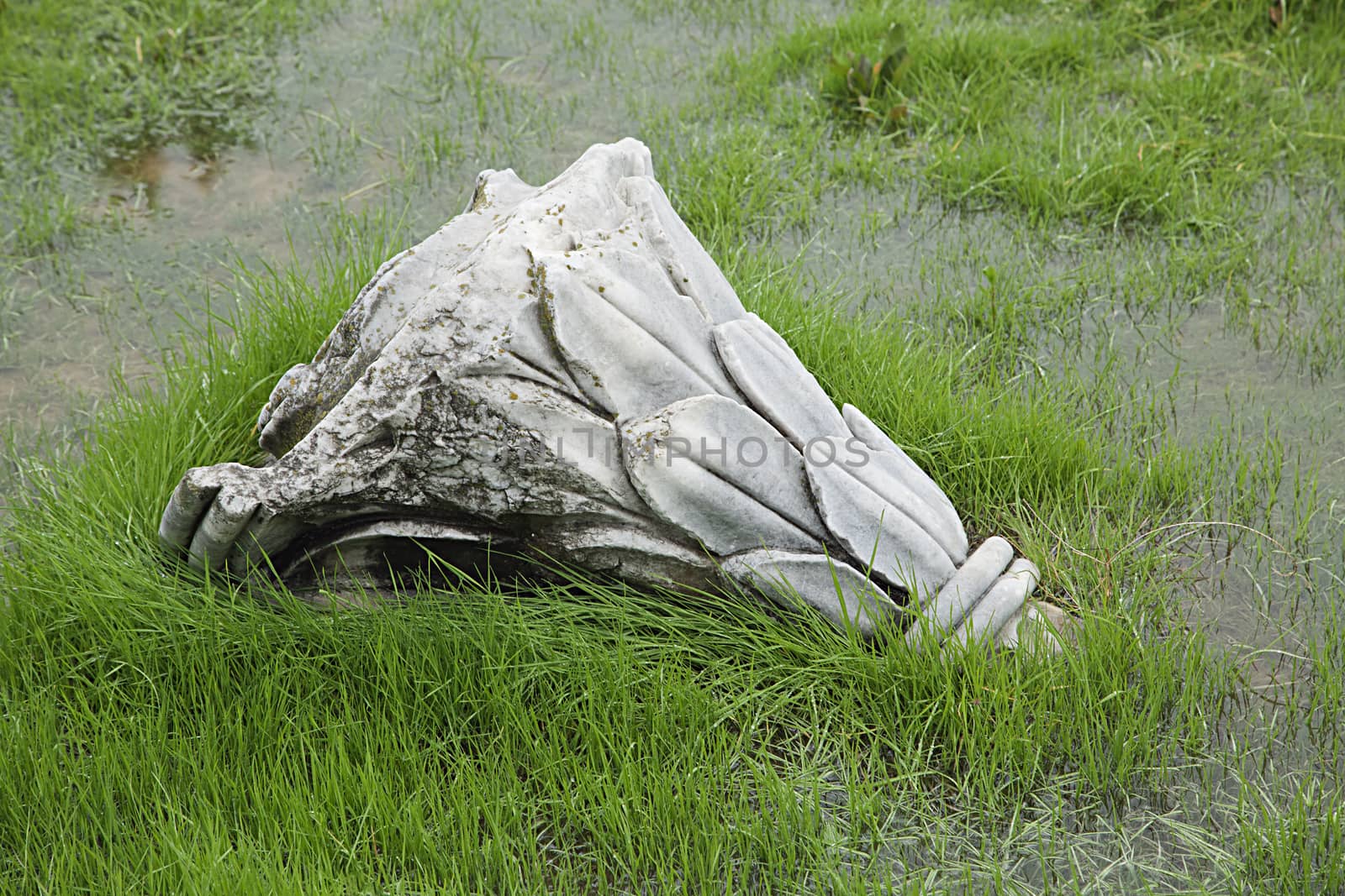 Ruined antique column in a rainy day