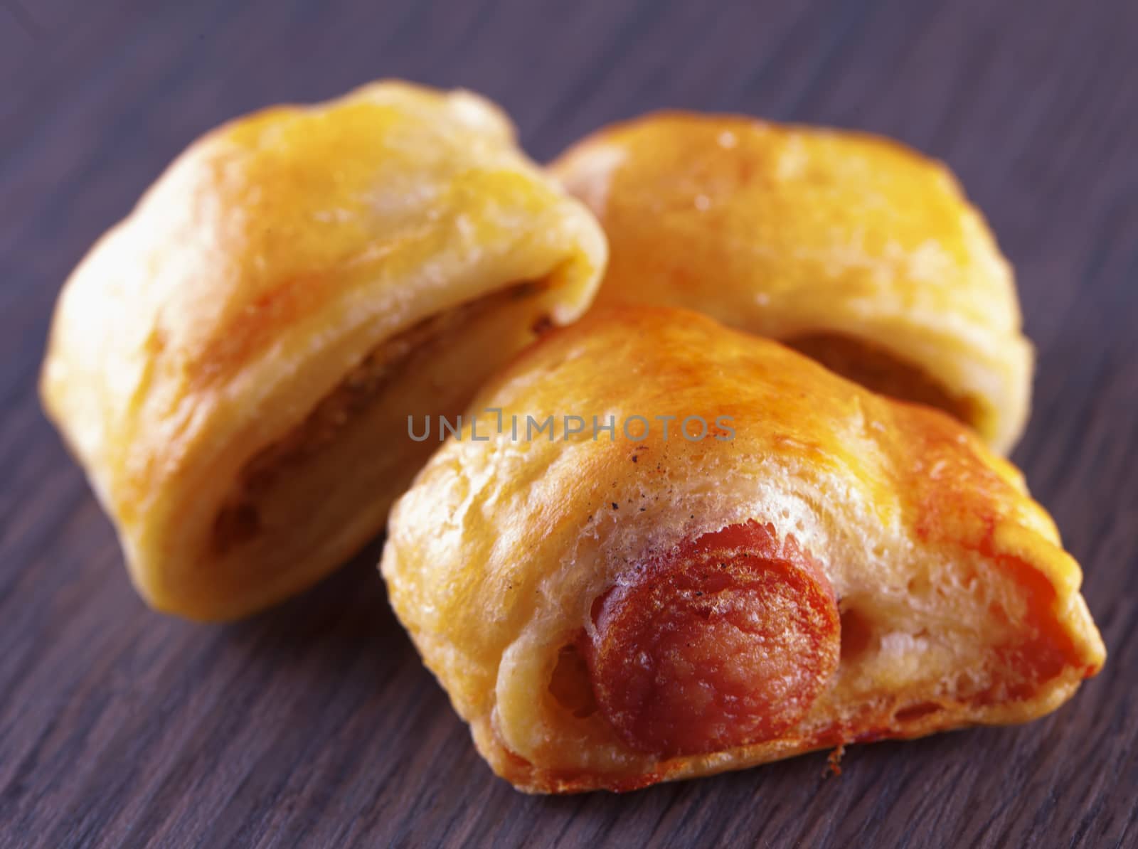 Three appetizers over a dark wooden table